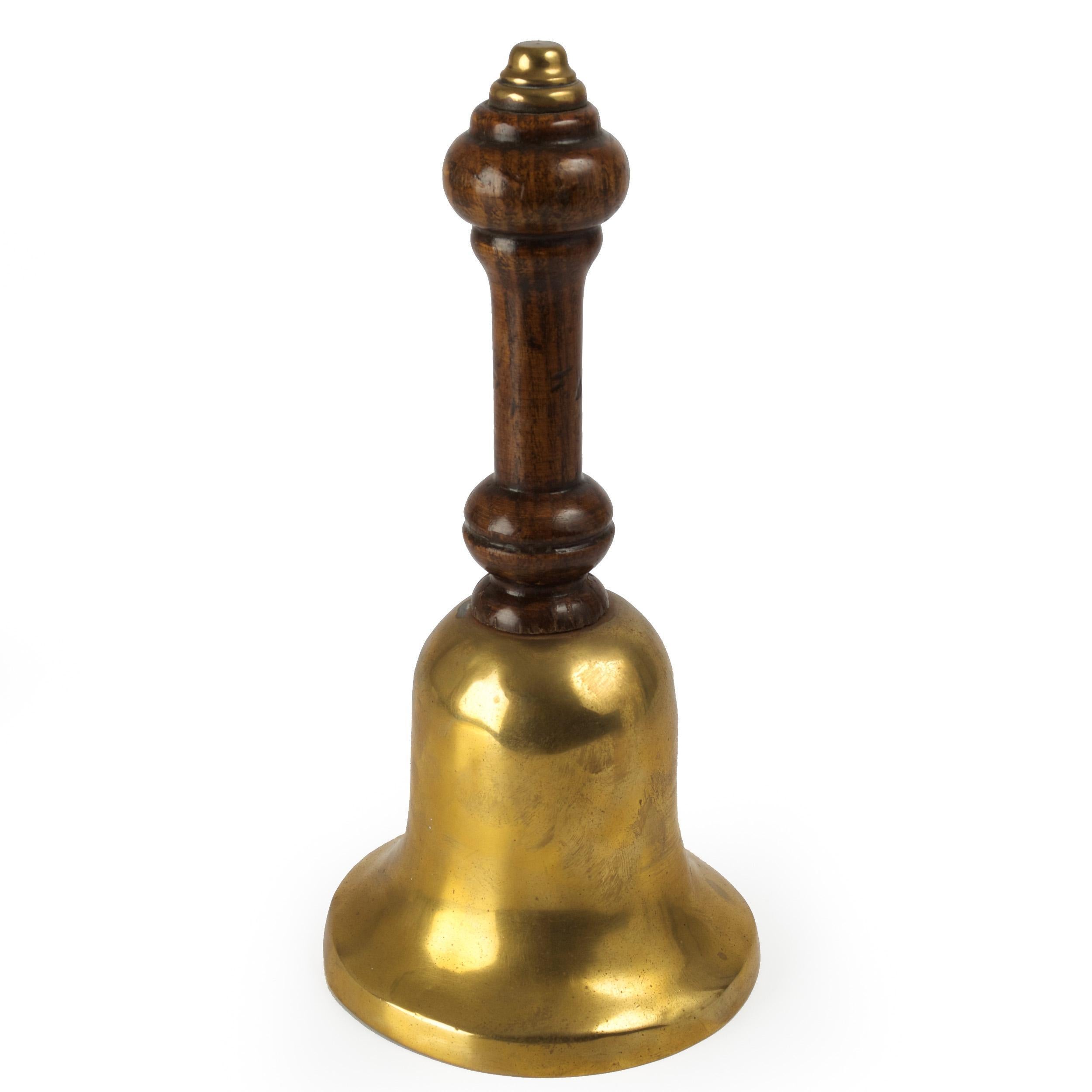 A good Victorian cast brass bell with a turned oak handle. Beautifully patinated, the handle glows through the early shellac and later waxes with turnings that are ever-so-slightly softened from regular handling.

Measurements: 9 3/8