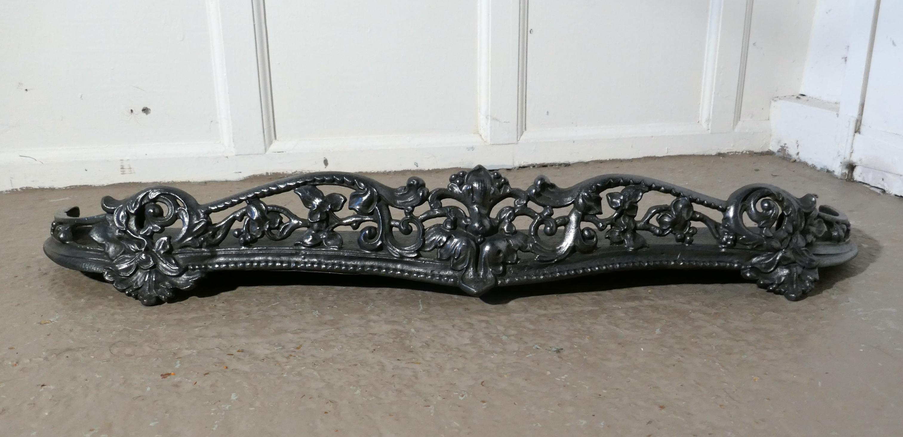 Victorian Art Nouveau Cast Iron Fender or dog grate

This is a Good Victorian Fender it is best quality and heavy, fenders like this were known a Dog Grates as they serve to rest the fire tools and keep any rolling ash in check, and this one is a