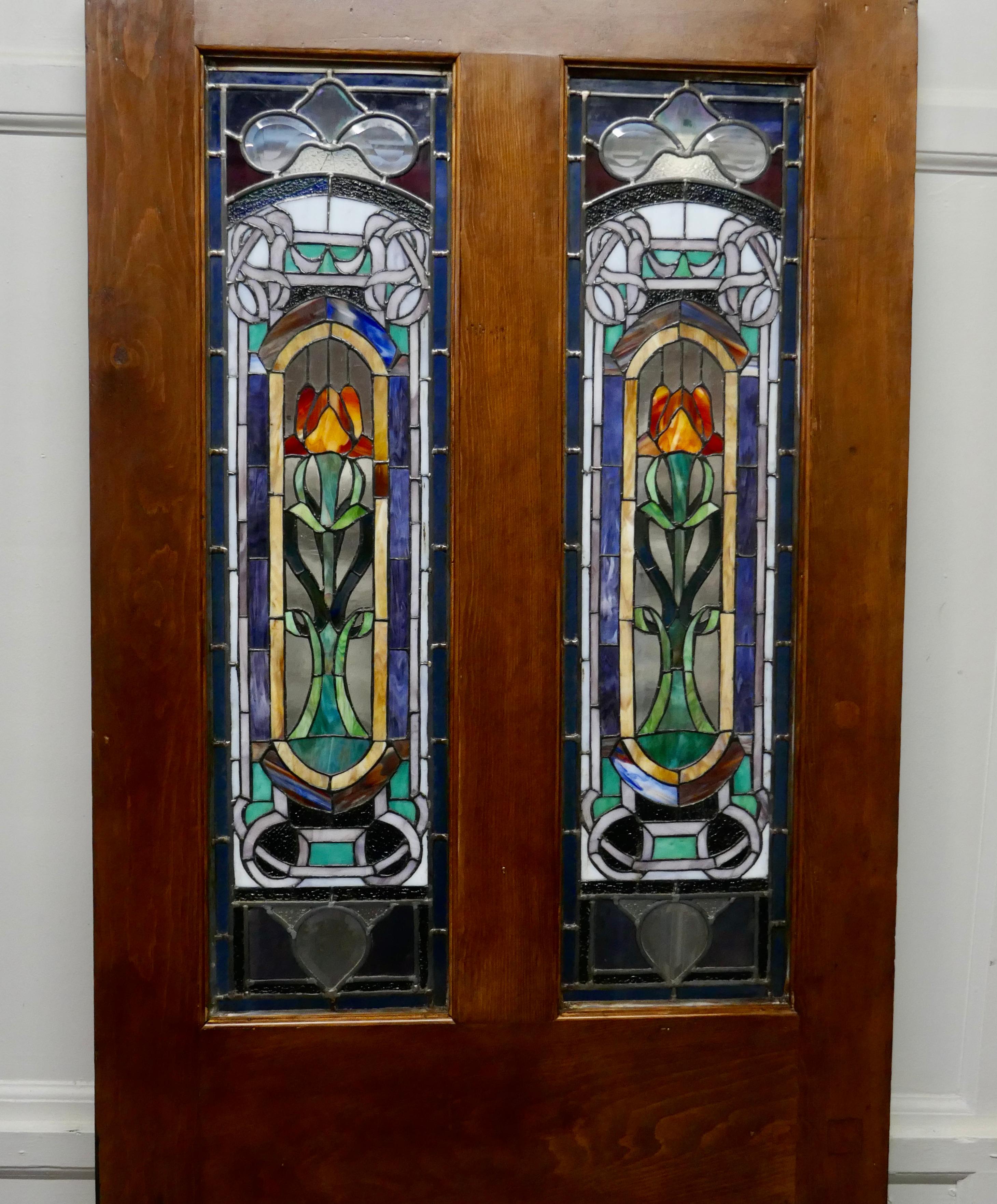 Victorian Art Nouveau stained glass panel door

This is a charming piece, set in to each of the 2 upper panels is a Stained Glass Panel
The glass is leaded and in a typical Art Nouveau Design with many colours, the only damage is in one panel at