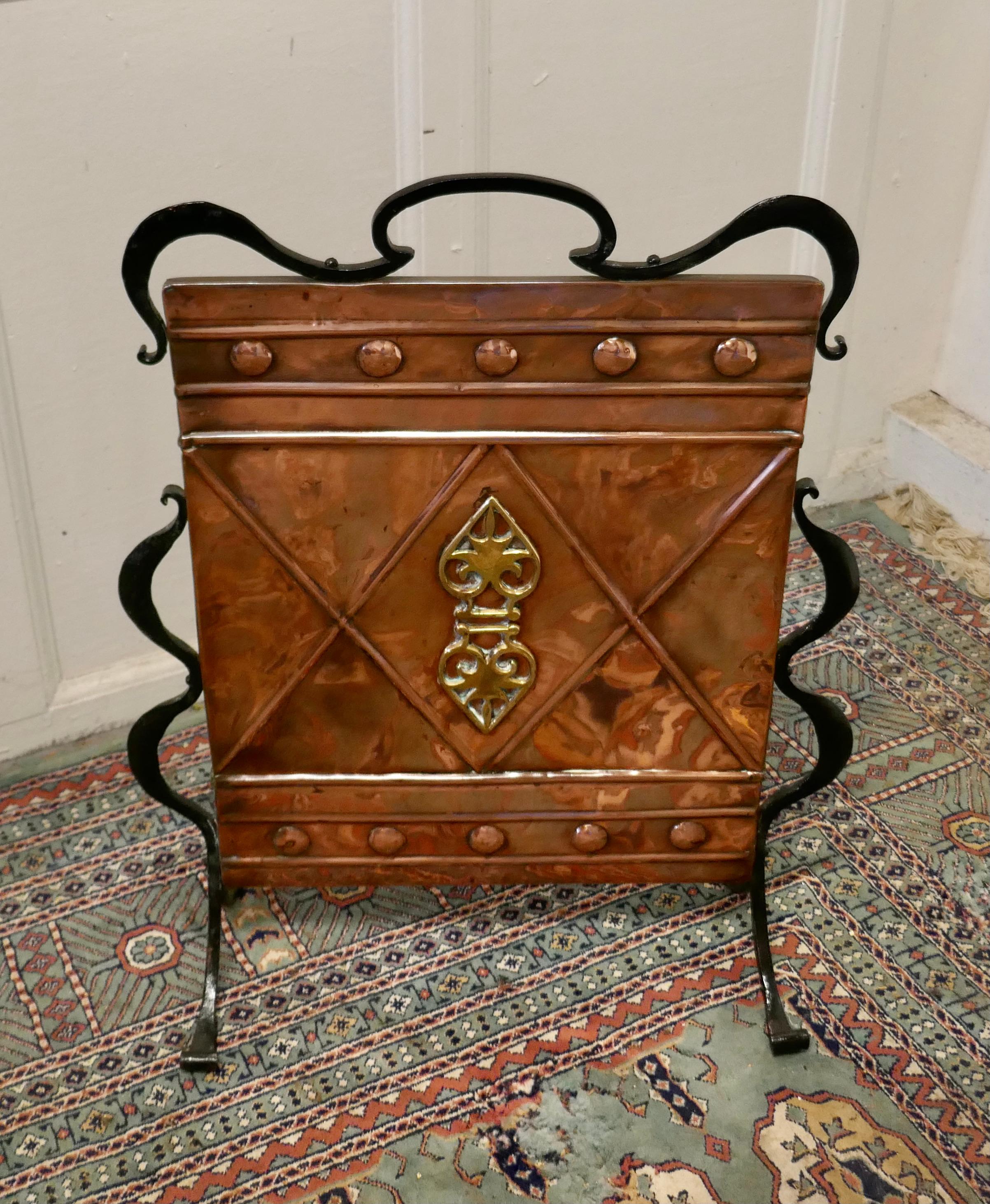 Victorian Arts and Crafts copper and iron fire screen

This is a classic in the Arts and Crafts style, it is a hand beaten copper screen, which is mounted on very stylish wrought Iron feet which carry all the way to the top culminating with