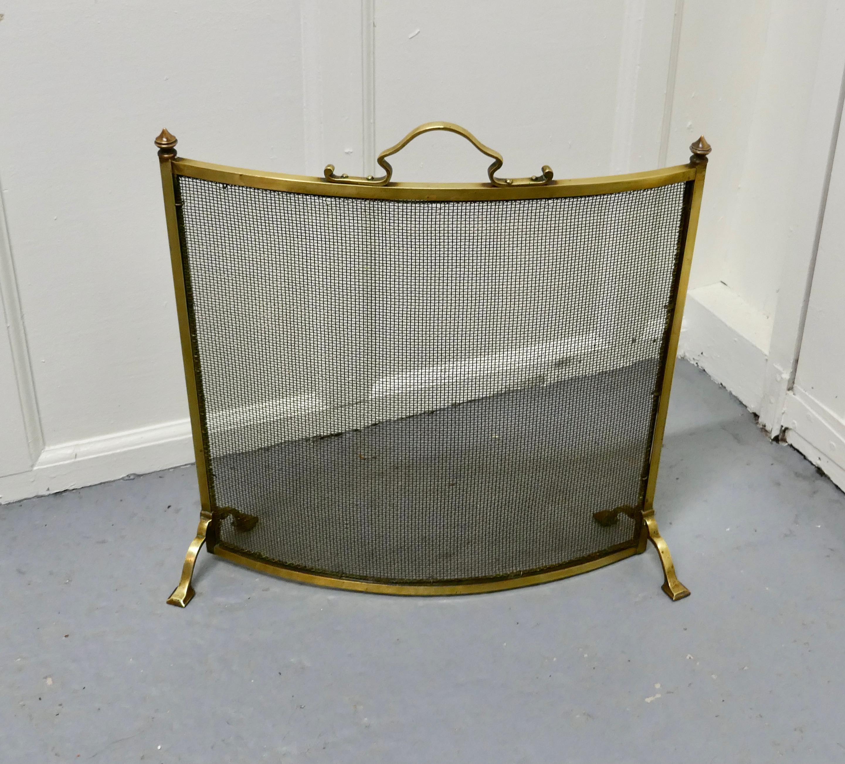 Victorian Arts & Crafts curved brass fire guard, spark screen

The fire guard is a stylish good quality piece it is made in brass with a fine brass mesh screen, it is a very unusual but very sensible curved shape.
A delightful decorative piece