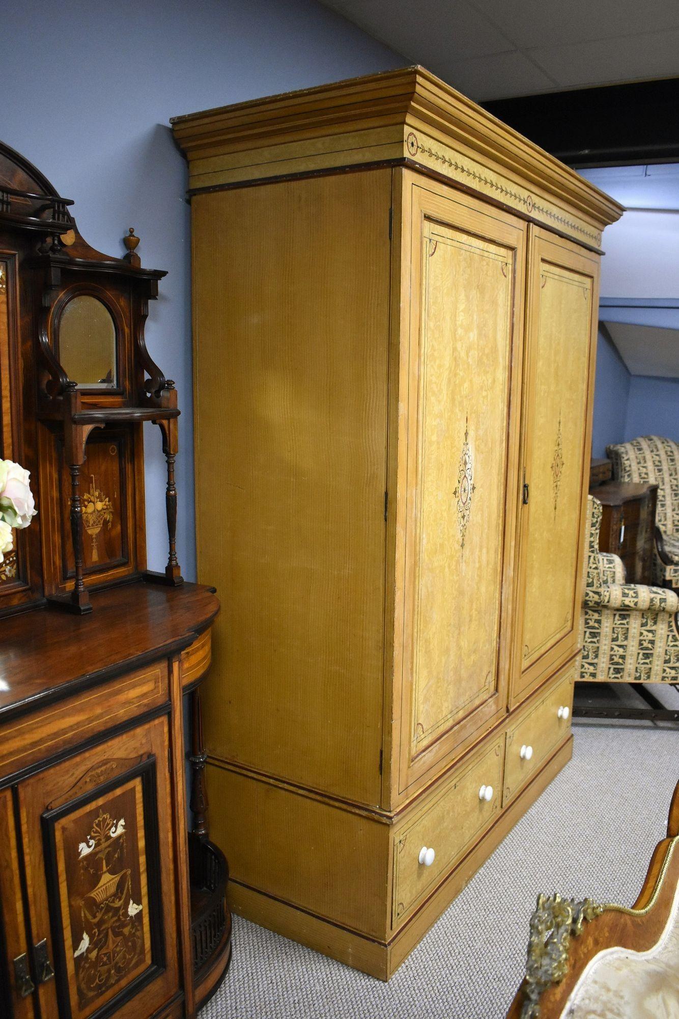 For sale is a good quality Victorian ash two door wardrobe, opening to removable shelves or ample hanging space, with two drawers below, each retaining their original handles. The wardrobe stands on a plinth base and is in good condition showing