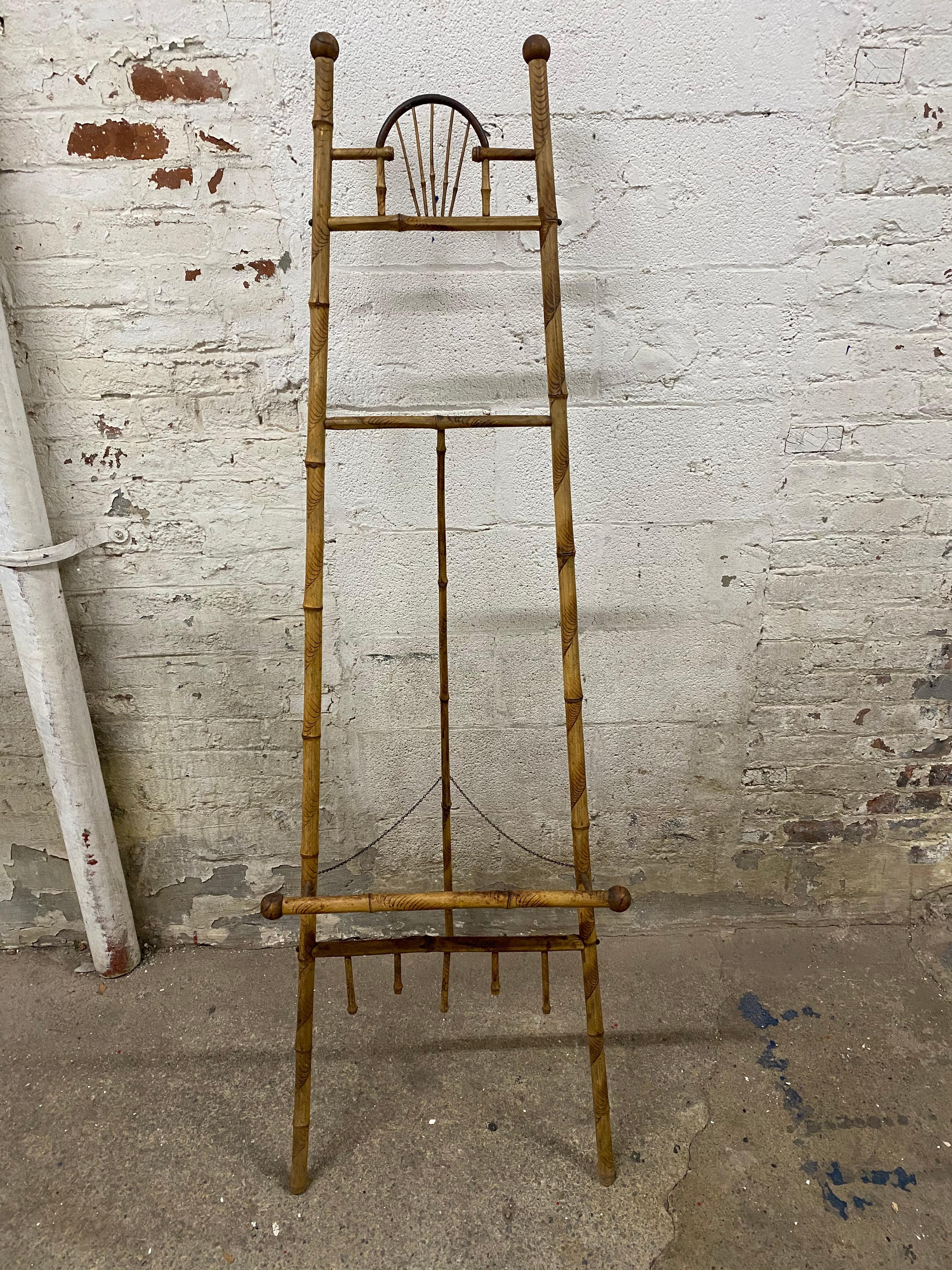 Victorian era bamboo easel. Delicate and refined with ball and stick motif. Structurally sound; it can hold a rather large painting, print, or mirror. Good overall condition.

Approximately 20