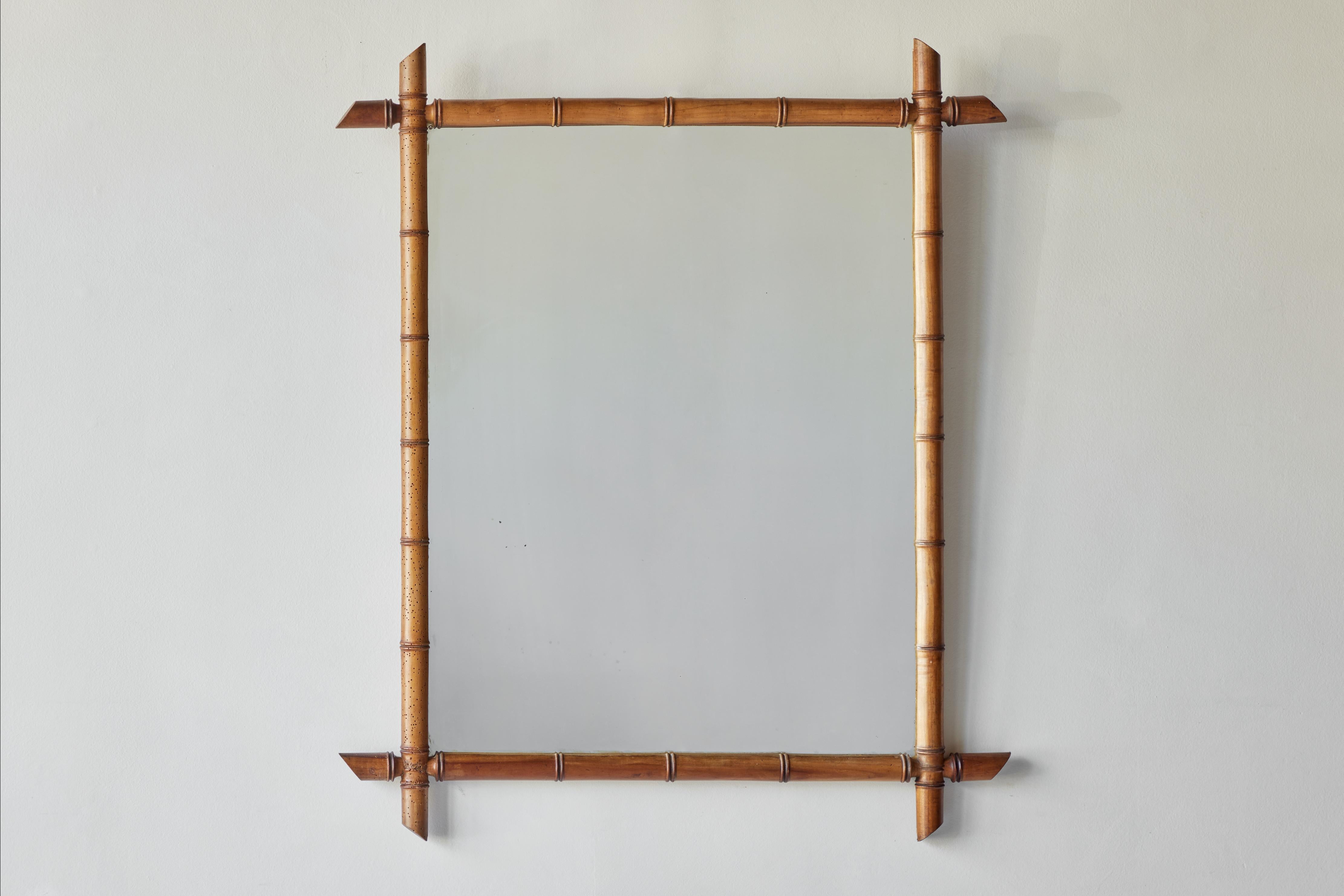 Early 20th century French wood turned bamboo mirror in a warm patina. Rustic mirror. Newly added wire and paper backing for a finished backside. 


