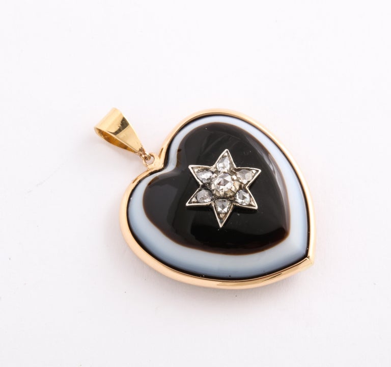 A Banded agate pendant with a diamond star casts a magnetic spell with its graphic design and contrast.  It is a marvel of gem cutting. It is understandable how a stone can be shaped into a  heart but cut so that the white of the agate is exposed