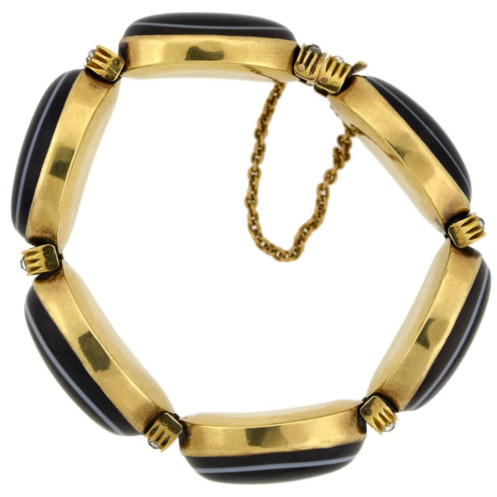 A exquisite banded agate and diamond bracelet from the Victorian (ca1880s) era! Crafted in rich 15kt yellow gold, this stunning piece is comprised of six large agate links which alternate with diamond lined connector loops, together forming a bold