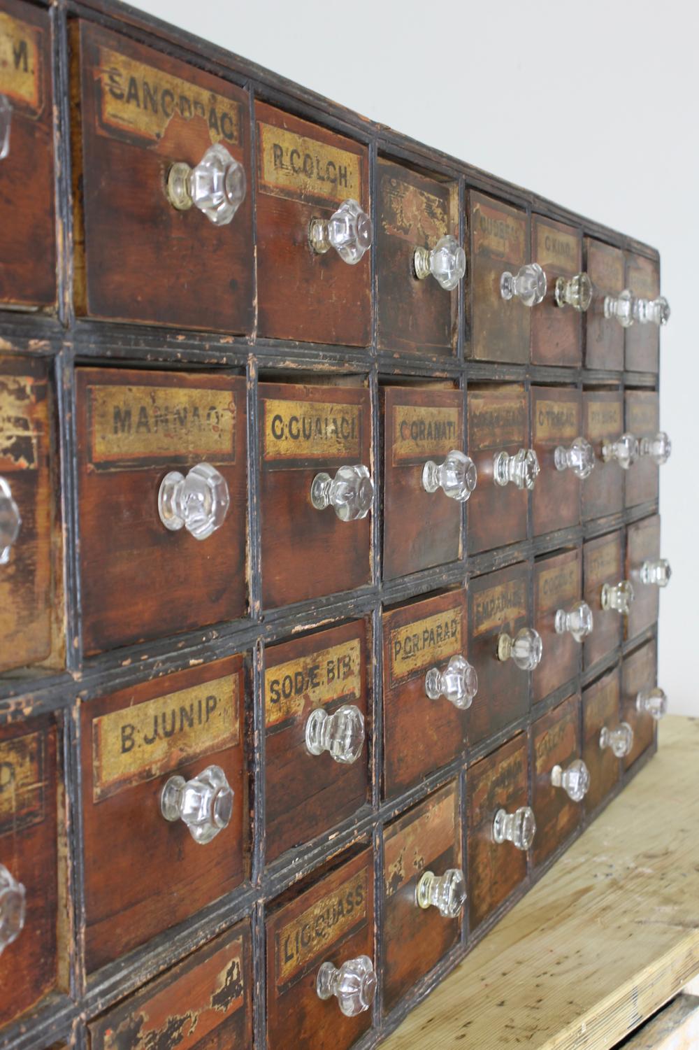 British Victorian Bank of Faux Mahogany and Ebonised Chemist or Apothecary Drawers