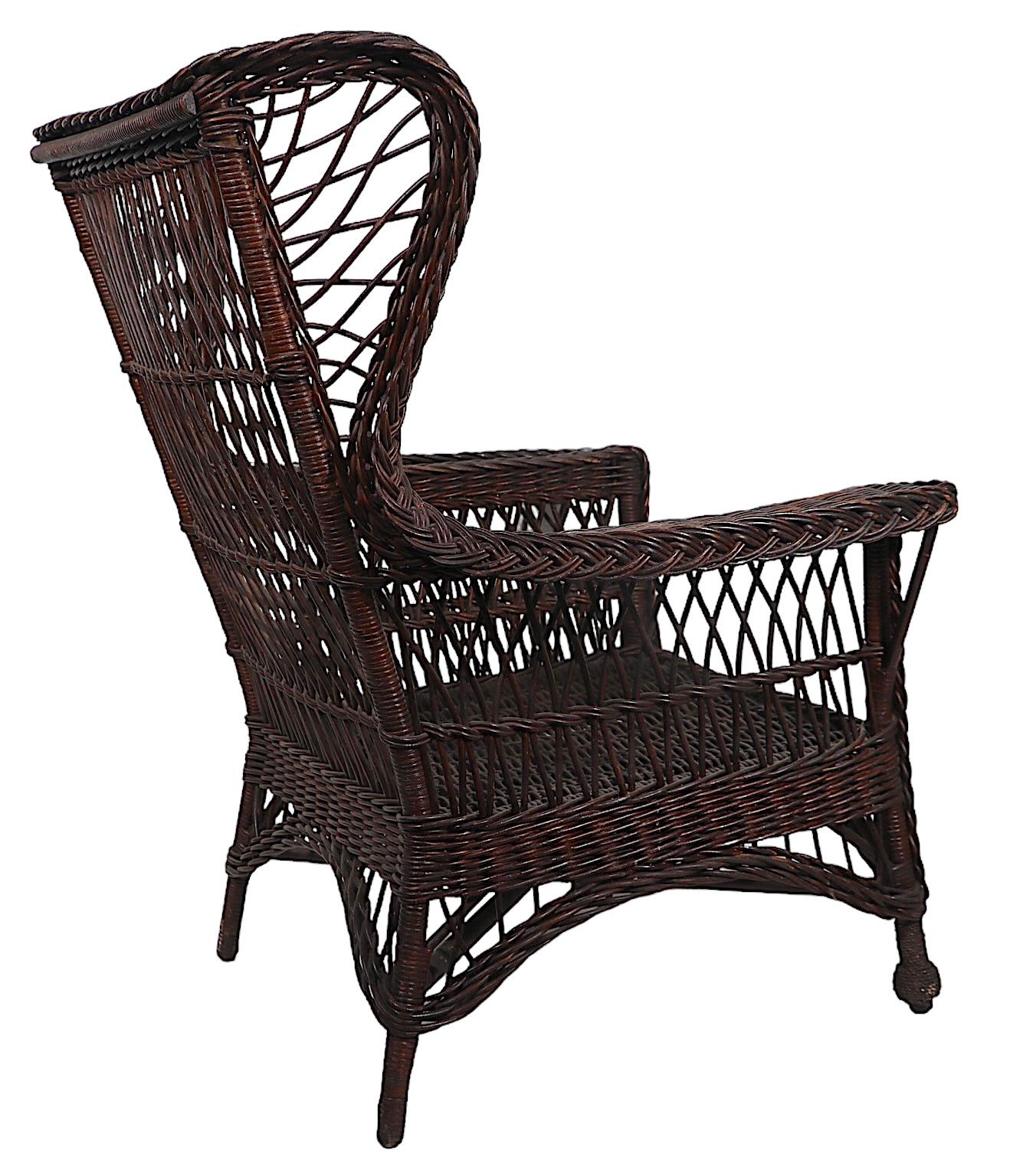 Classic Bar Harbor Victorian wicker arm, lounge, wing  chair. The chair has classic braided woven wicker edging, with cross hatched wicker back, and  seat, beehive feet and  a magazine rack arm. The chair is in very good, original, clean and ready