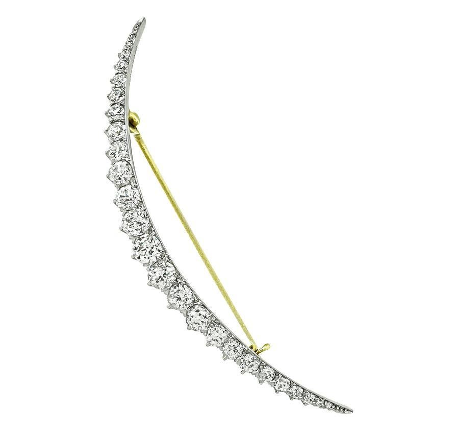 This is a stunning platinum and 18k yellow gold crescent pin by BB & B from the Victorian era. The pin is set with sparkling old mine cut diamonds that weigh approximately 3.50ct. The color of the diamonds is E-F with VS clarity. The pin measures