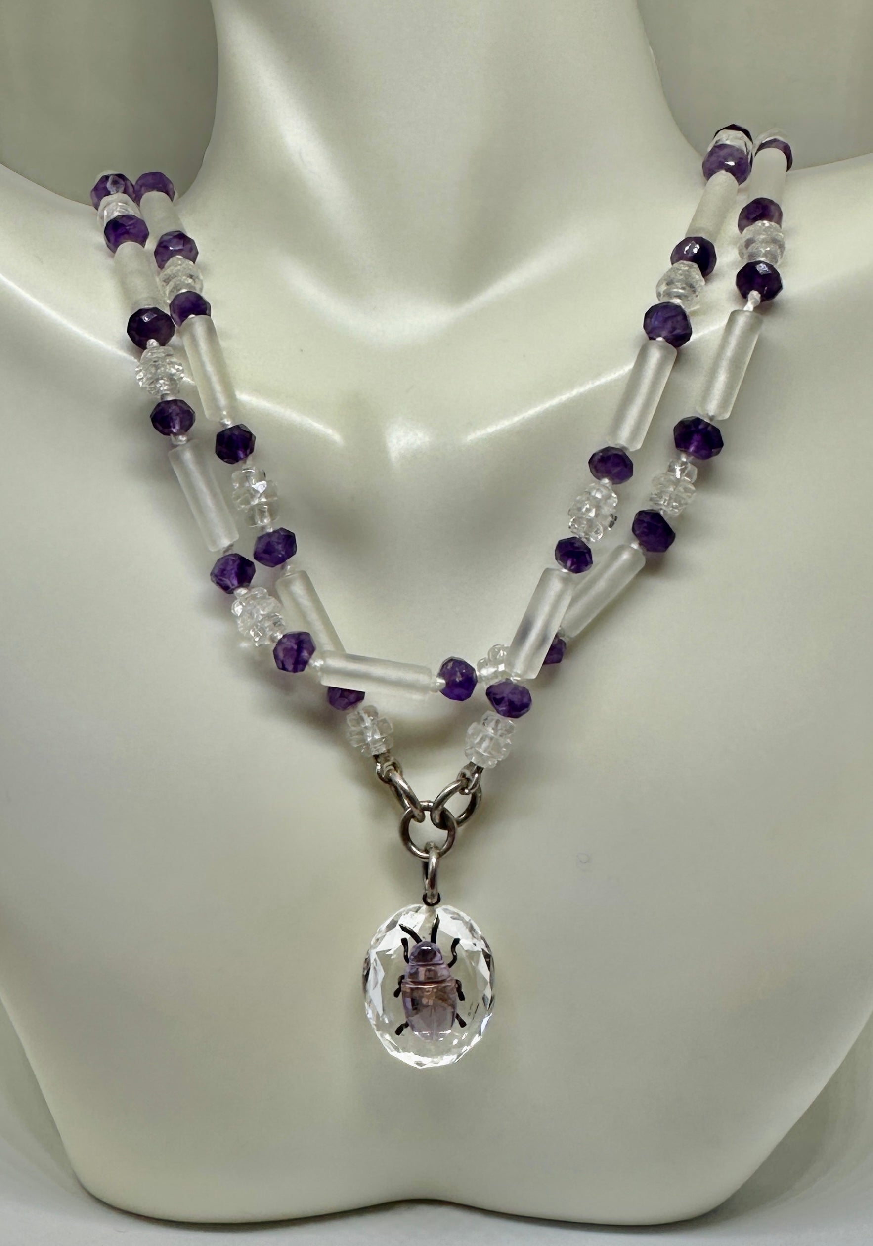 This is a stunning Victorian to Art Deco Beetle Bug Insect Pendant Necklace in Amethyst and Rock Crystal.  The necklace is 27 inches long.  The extraordinary jewel features an amethyst and rock crystal beetle pendant.  The beetle is created with