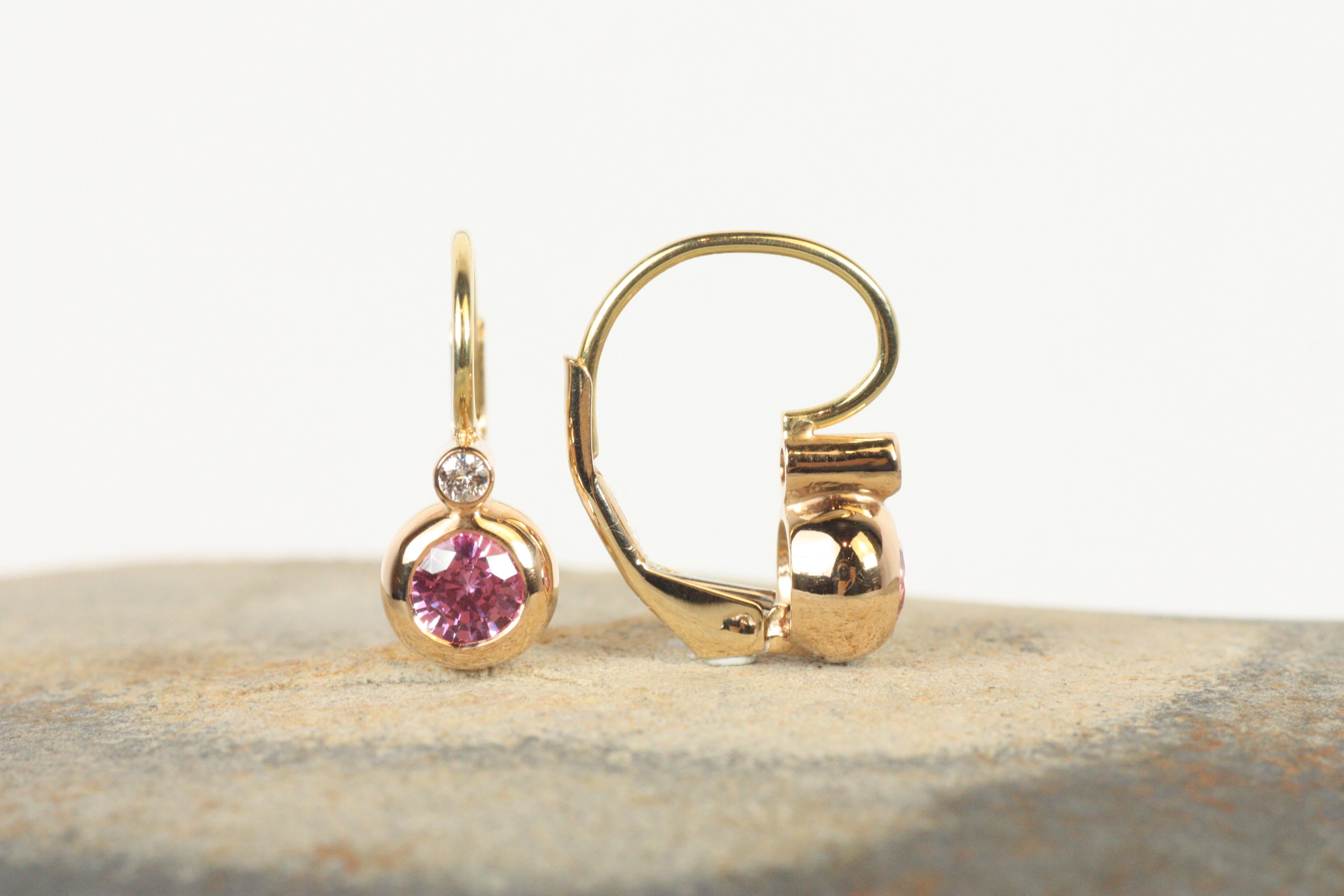 The Victorian Bezel Earrings capture a blend of vintage charm and modern elegance. Set in 18K rose gold, these earrings feature brilliant pink sapphires paired with sparkling diamonds, bezel-set for a sleek and refined look. The warm blush of rose