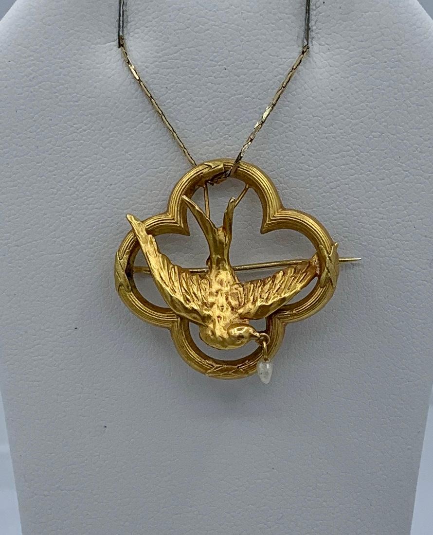 This is a gorgeous and very rare antique Victorian French Swallow Bird Dove pendant brooch in 18 Karat Gold adorned with a Pearl drop in an extraordinary three-dimensional design of a flying bird with the pearl in its mouth.  During the Victorian