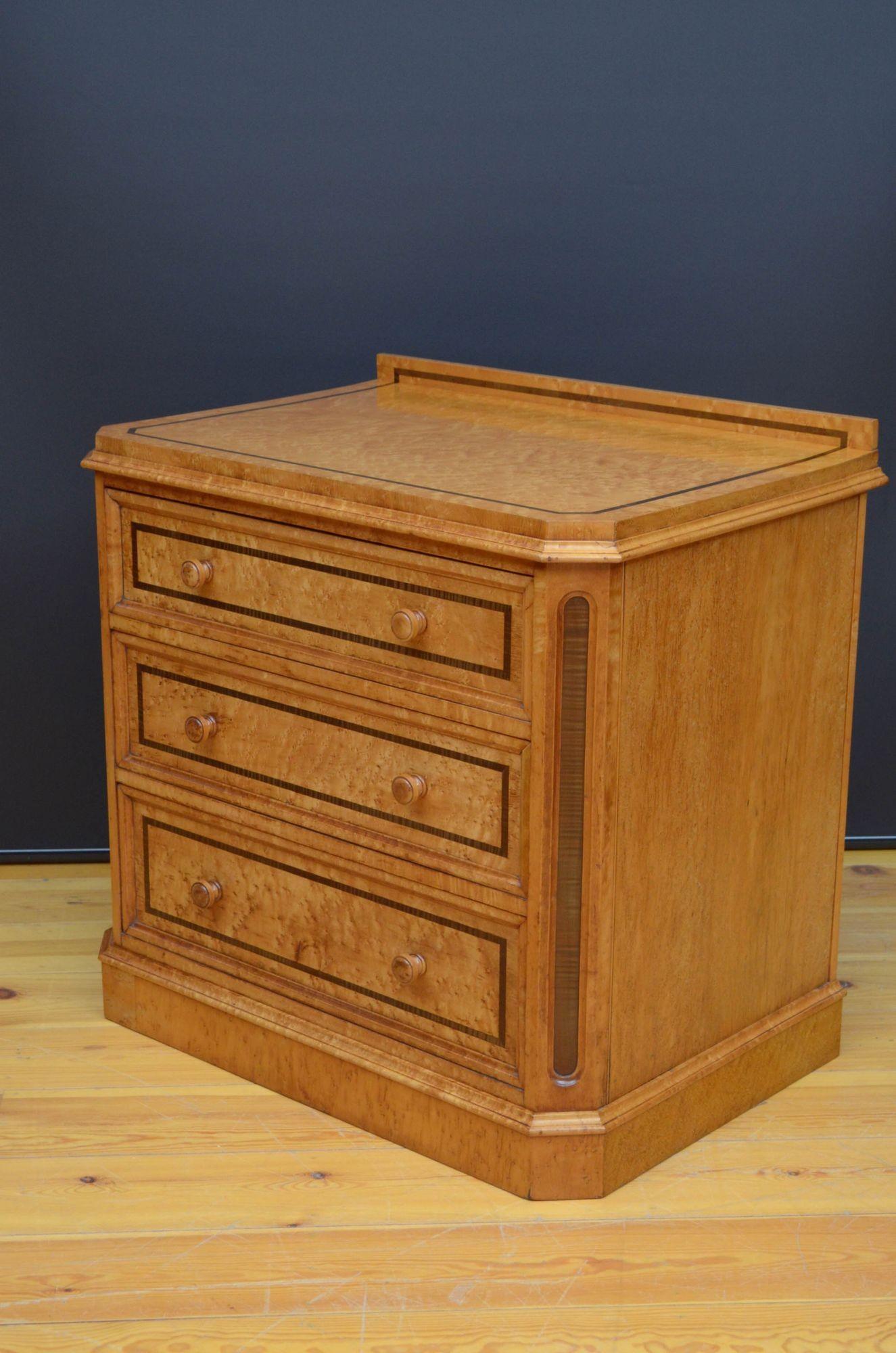 J011 Victorian bird's eye maple chest of drawers of narrow proportions, having inlaid upstand and inlaid top above three moulded and inlaid drawers fitted with original turned knobs and flanked by inlaid canted corners, all standing on moulded