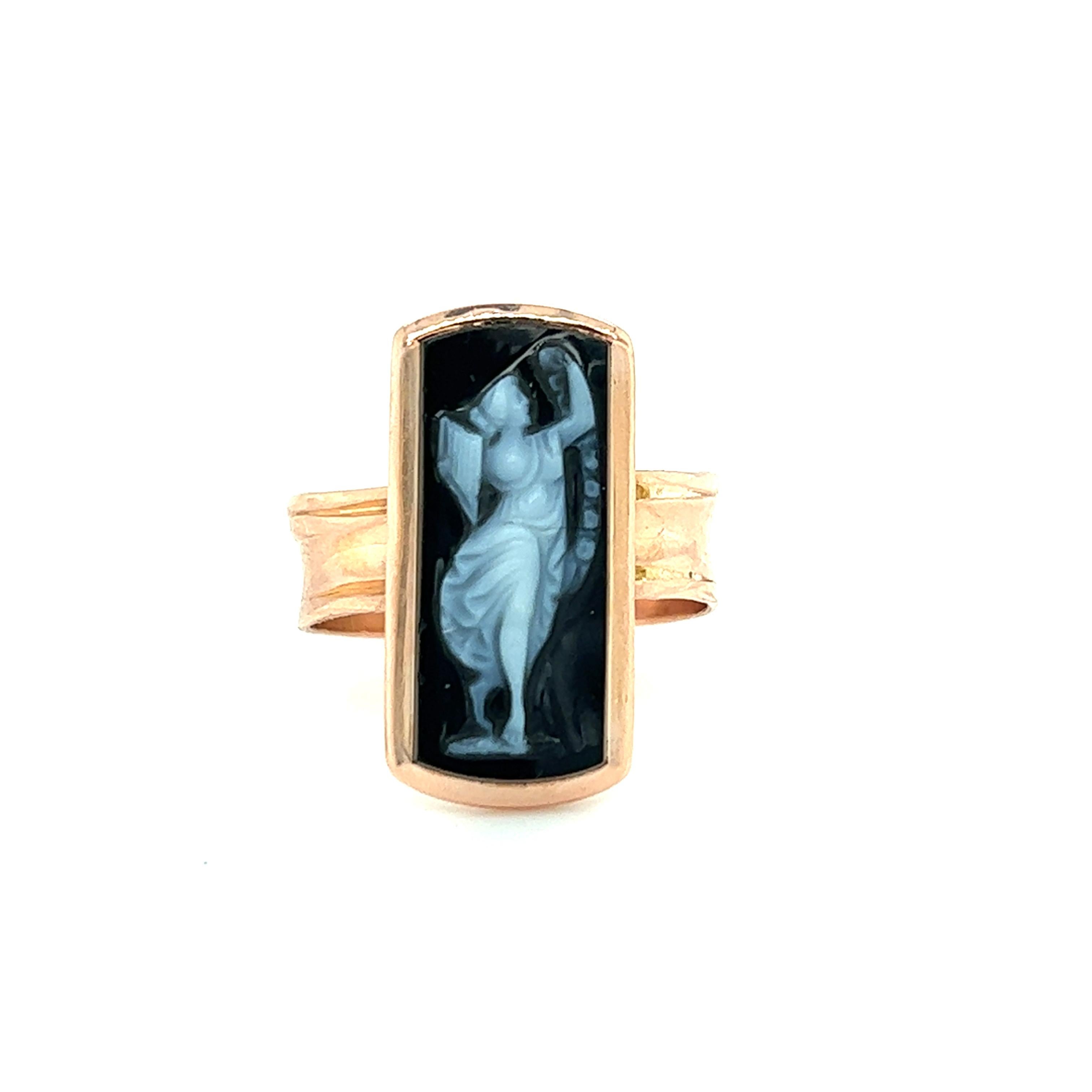 One 14-karat rose gold Victorian ring set with one 17x8mm rectangular black and white hard stone cameo. The ring is a finger size 5.75 and is resizable. Sizing is not included. The ring weighs 4.1 grams in total weight.  