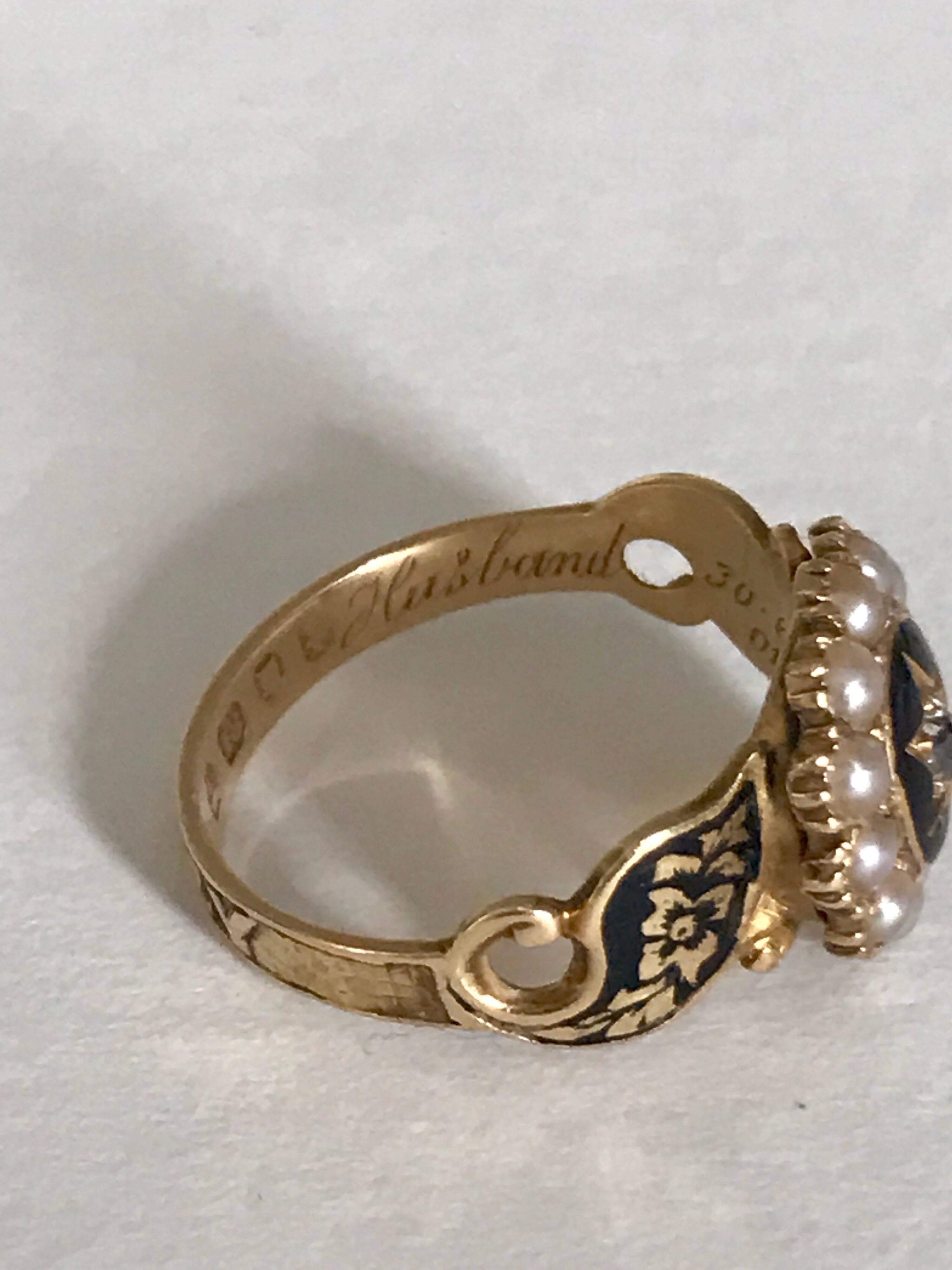 This lovely example of a mourning ring is set with 12 creamy white natural seed pearls, each 2 mm in diameter and one old European cut diamond at the centre 2.5mm. The ring is hand crafted in 18 karat gold and fully hallmarked with English marks