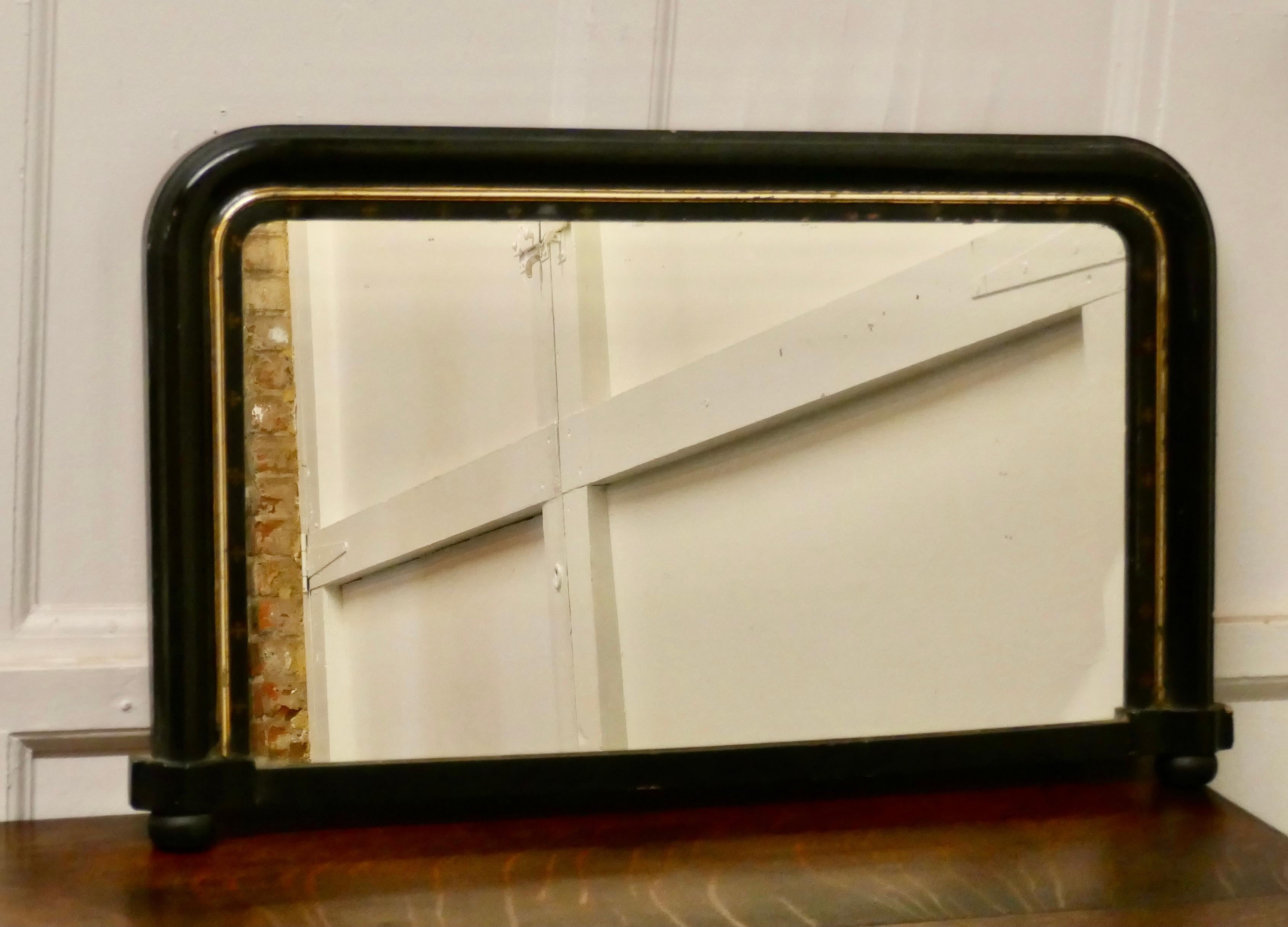 Victorian black lacquer over-mantel mirror

The mirror has a 3” Frame which has rounded top corners, it has a dainty gilt decorated border and it stands on small black bun feet
The mirror glass appears to be original and it is in good