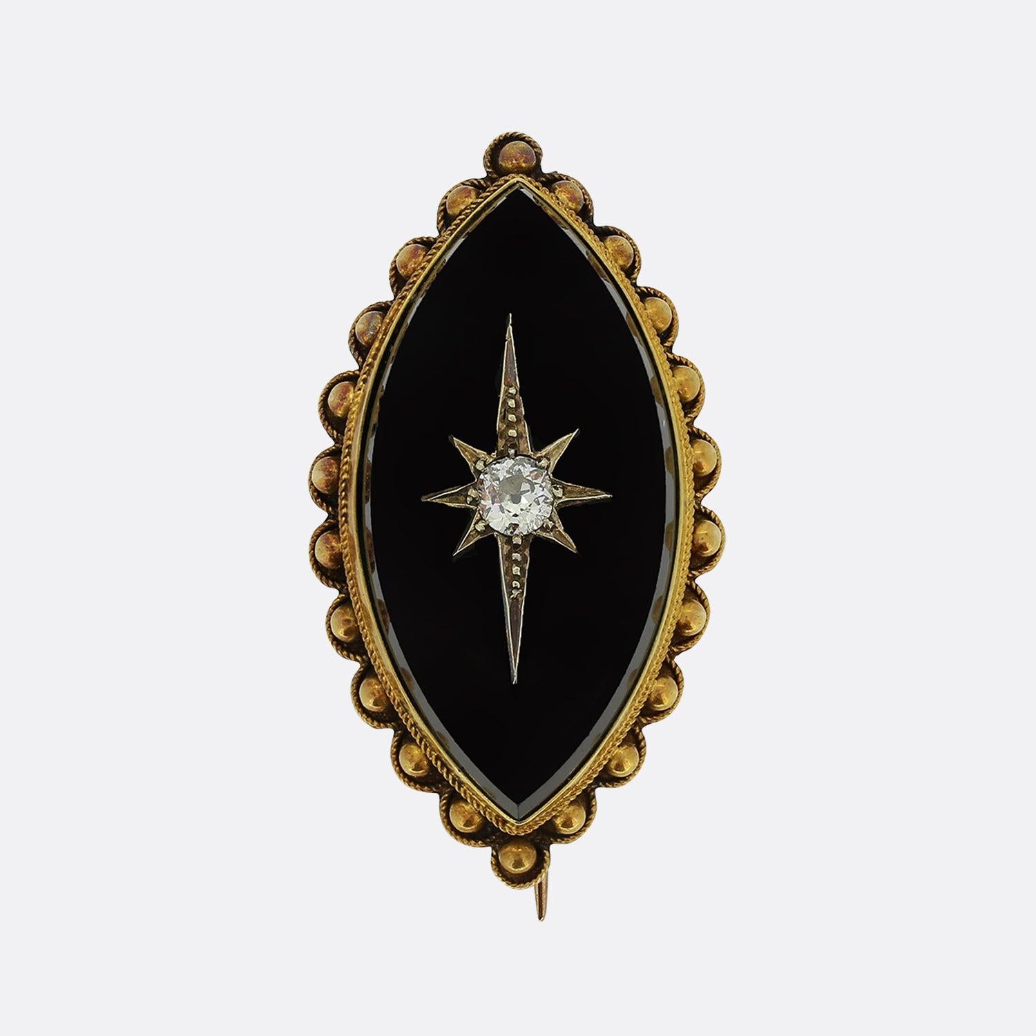 This is a Victorian 15ct yellow gold mourning brooch. The brooch has beautiful etruscan style detail around the edges, a black onyx face with a star set old cut diamond. Like most mourning jewellery the back of the brooch opens up in a locket