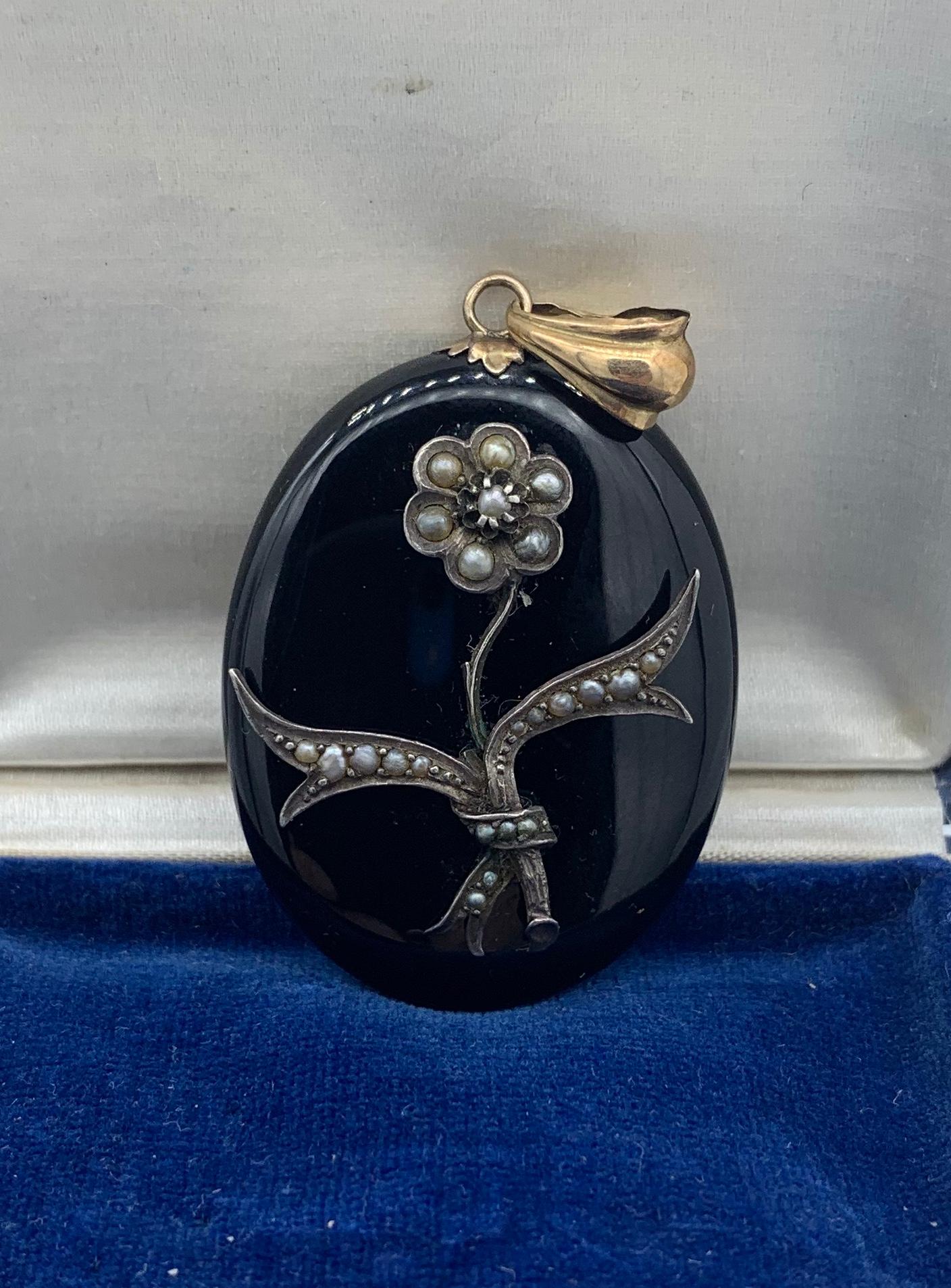 A magnificent Victorian - Belle Epoque Picture locket pendant necklace in Black Onyx, and Gold and Silver with Pearl adornments in a Flower Motif design.  This is one of the most stunning Victorian lockets we have seen.  The locket is an oval locket