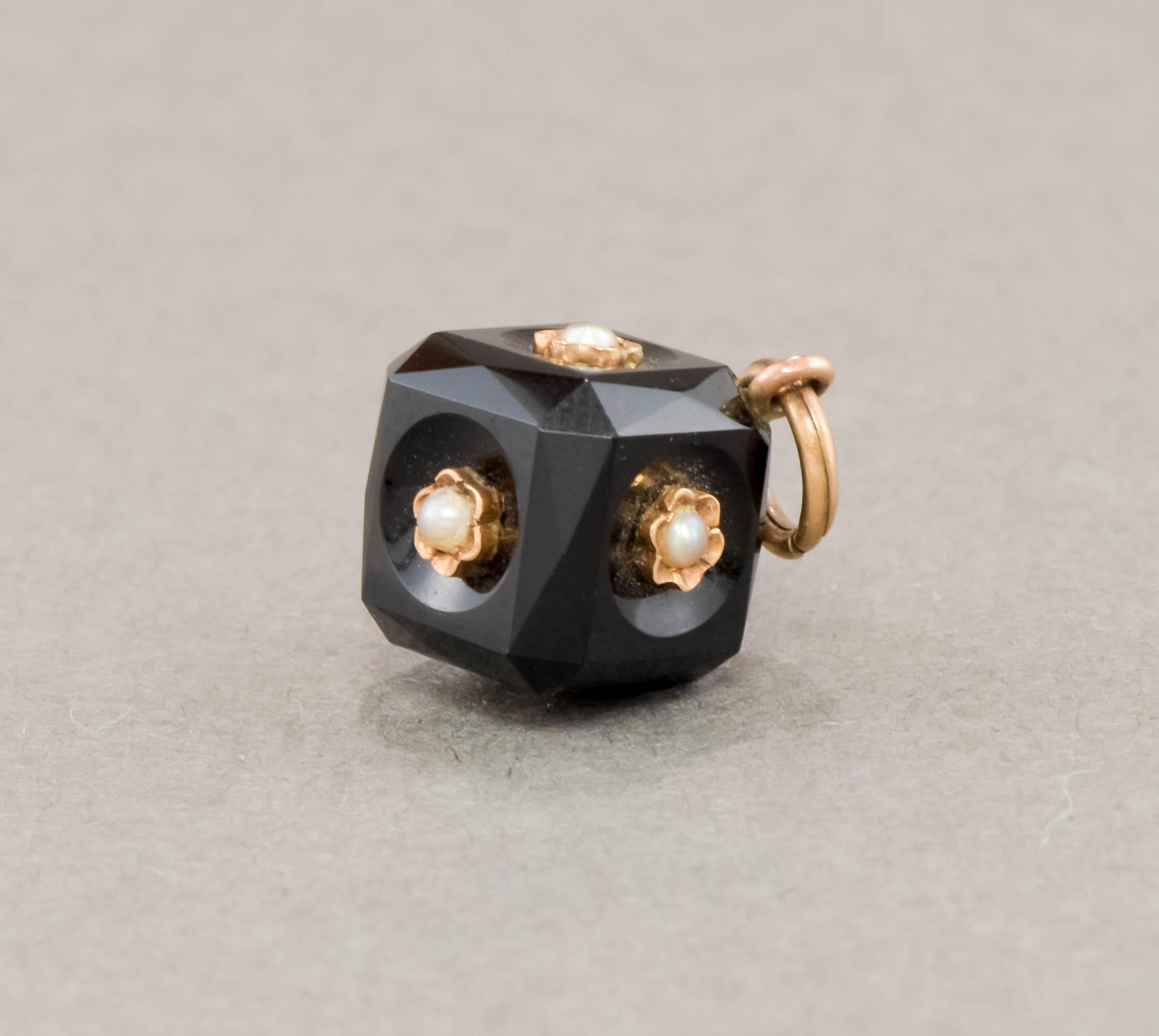 In wonderful original condition, this elegant Victorian era onyx cube with flower blossoms was originally a pocket watch fob.  Perhaps a mourning piece, given the black onyx and the pearls which symbolized tears, it would have been suspended on a