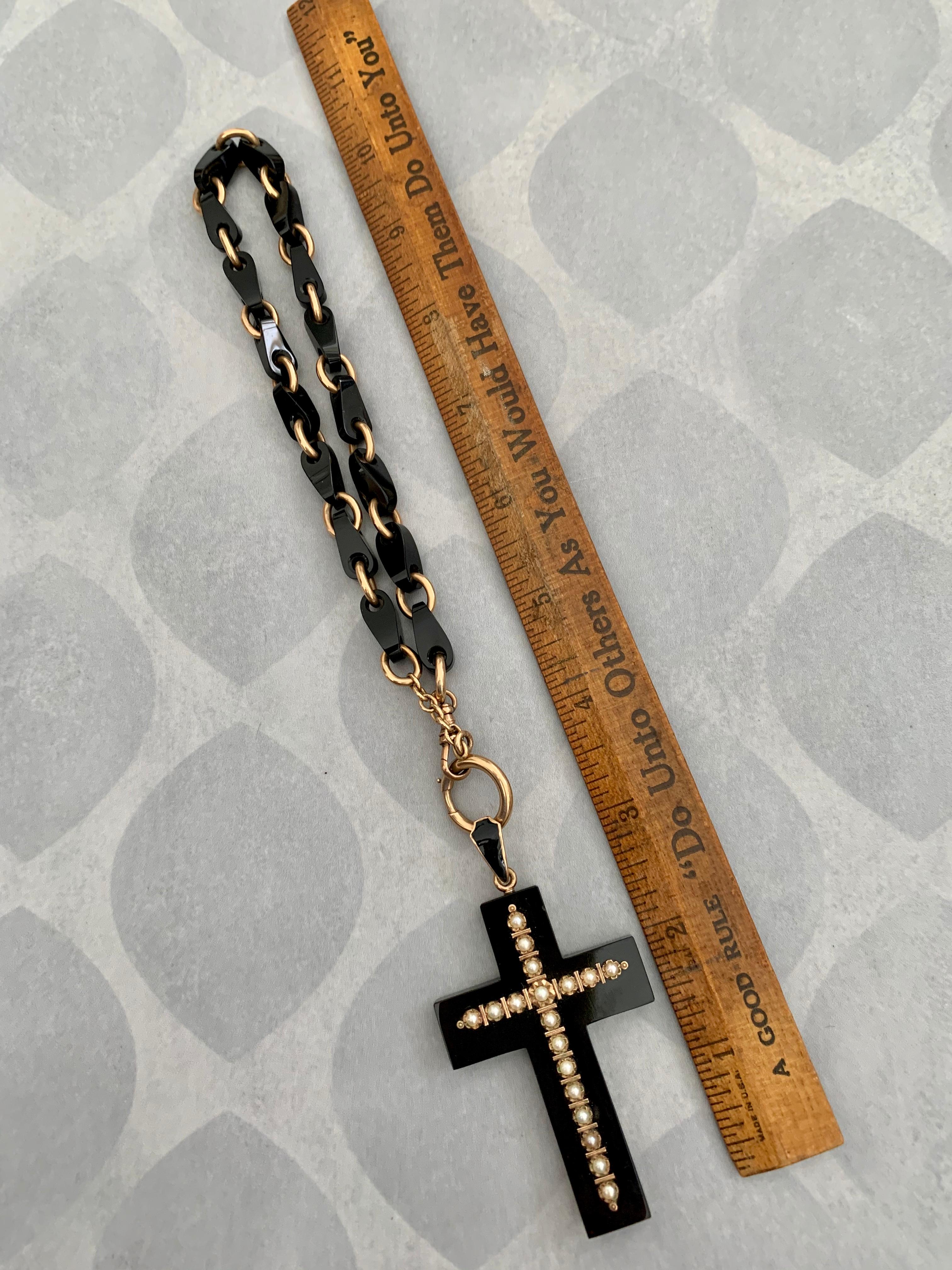 This Victorian black Onyx cross pendant is accented with 18 seed Pearls, set in 14k yellow Gold.  The chain alternates Gold links with black Onyx and 15