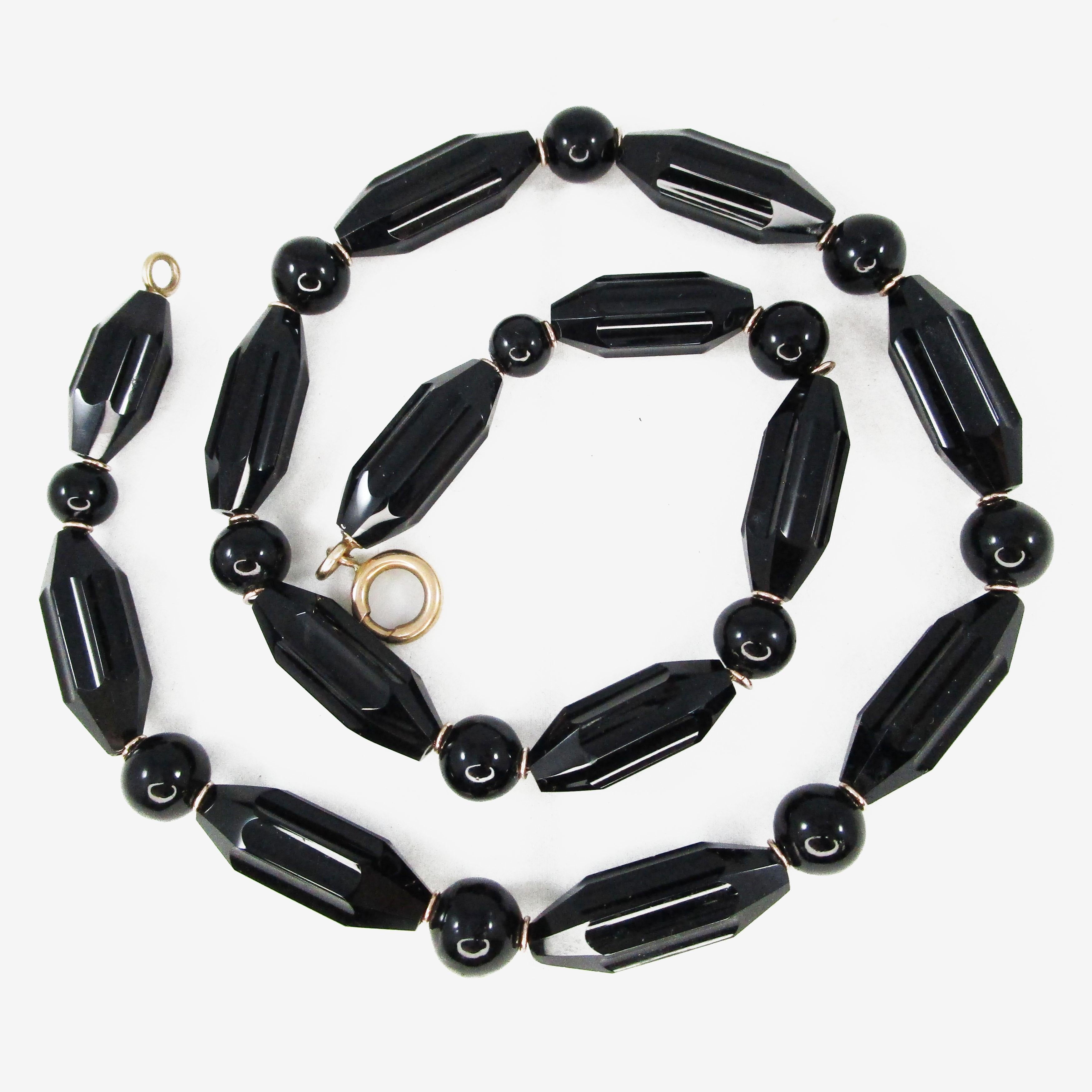 This necklace is THE necklace of all time!! It is an original Victorian piece in excellent condition--the black onyx beads have no chips or scratches, and the yellow gold clasps and links are positively gleaming! This necklace would've been made to