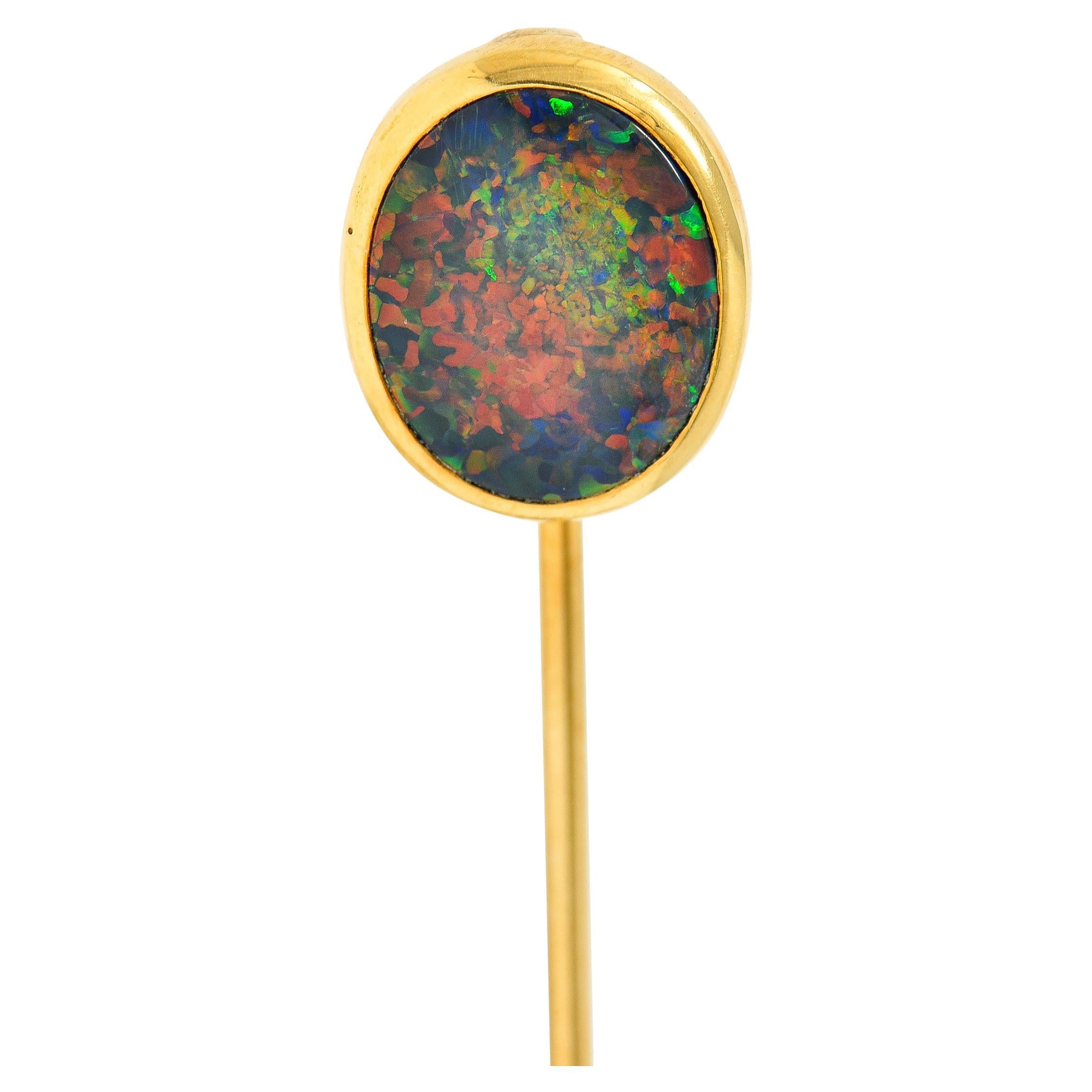 Featuring an oval black opal double cabochon measuring approximately 10.9 x 9.5 mm

Opaque dark gray body color with very strong spectral play-of-color

Bezel set in a polished gold surround

Tested as 18 karat gold

Circa: 1900

Head measures: 1/2