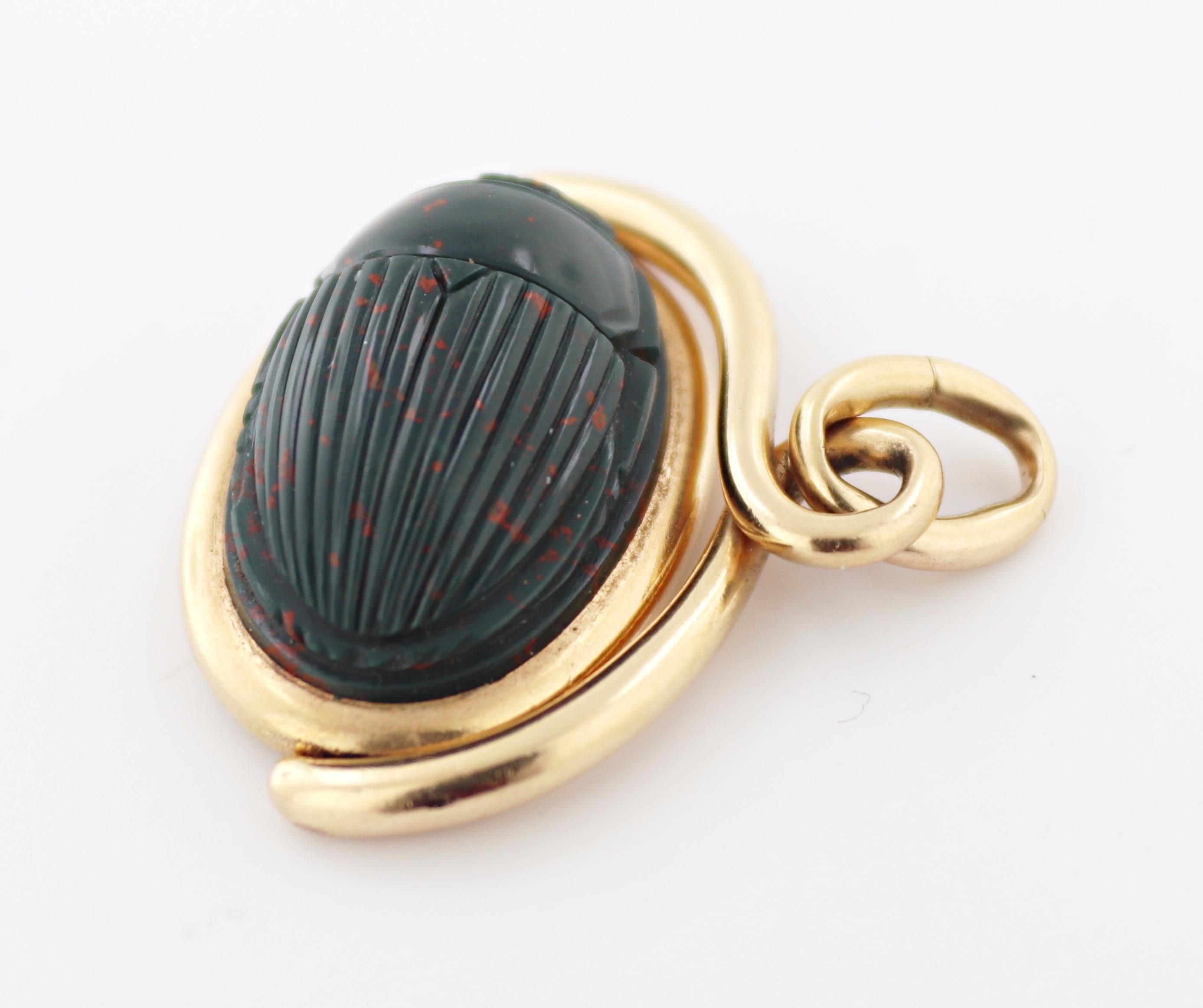 The carved bloodstone depicts a scarab, the bottom features an intaglio
seal of a horse, 19.5 X 12.5 X 8.1 mm, set in 14k rose gold swivel fob
mounting, Gross Weight: 6.86 grams.