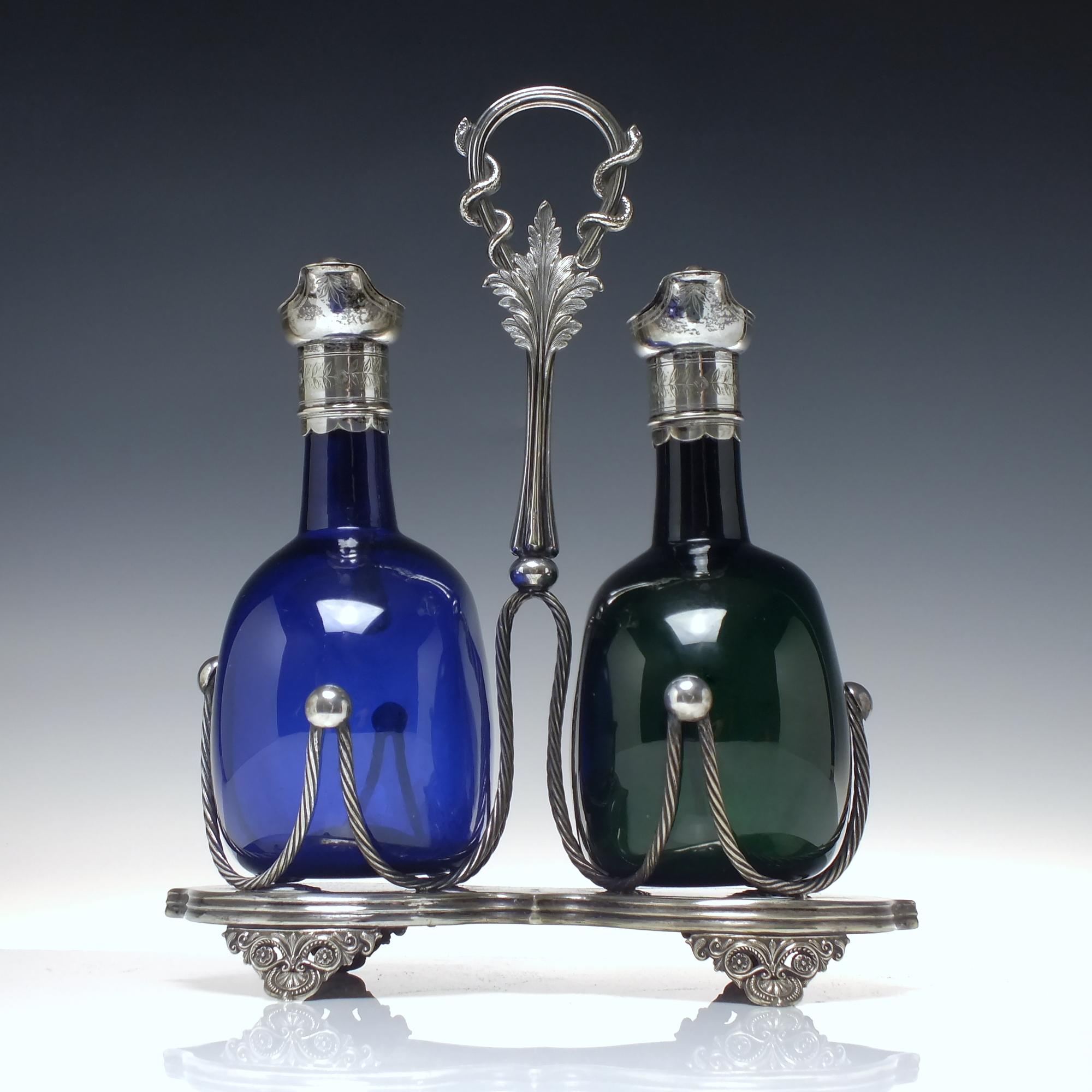 Technical Description 

A magnificent pair of Victorian Flaggons, one blue and one green with silver plated cap and lids with the original internal stoppers with silver plated caps. Applied handles and deep polished pontils. The silver-plated