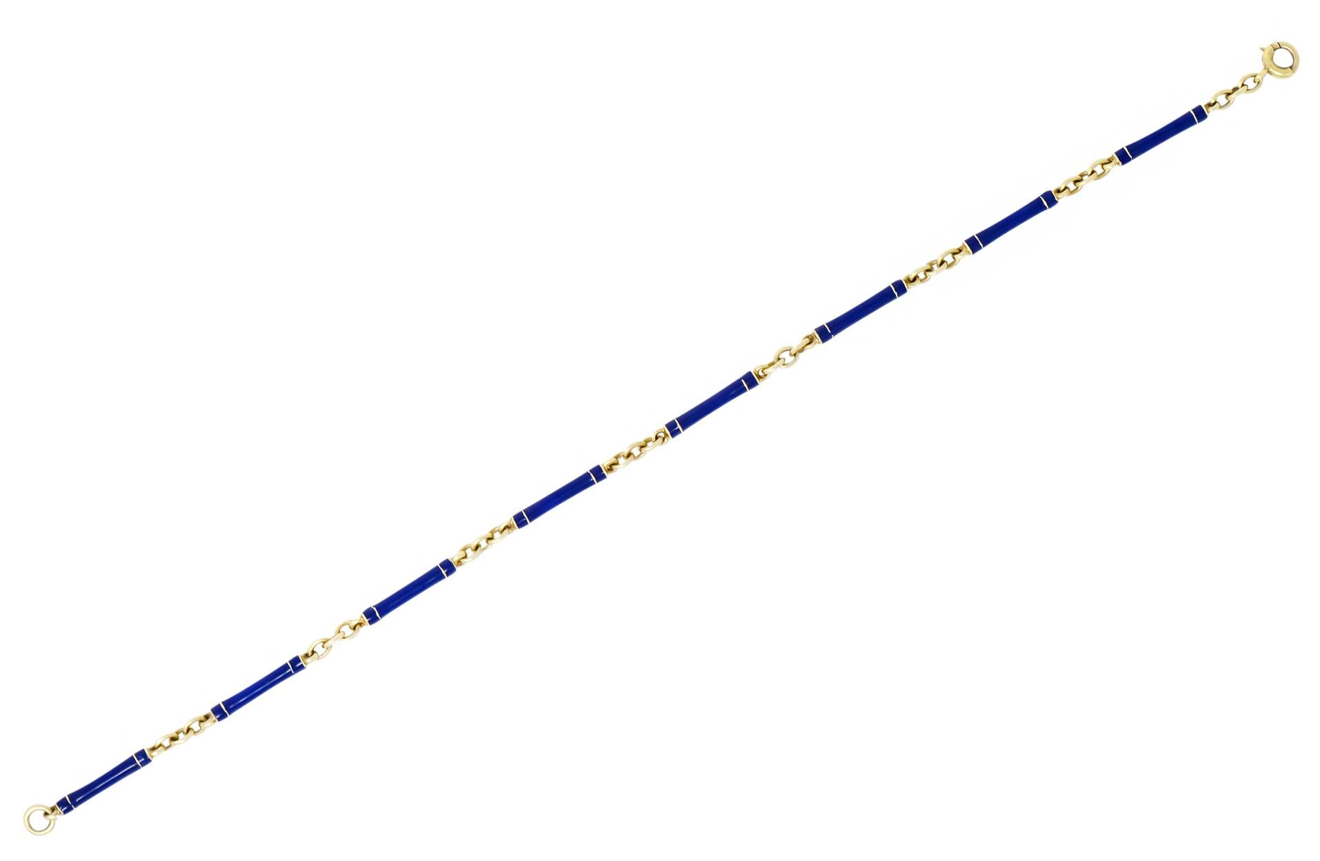 Bracelet designed with elongated thin links in cobalt blue enamel, with little to no loss, consistent with age, wear, and use

Each link end is accented by a thin stripe of gold

With three gold link spacers between elongated segments

Completed by