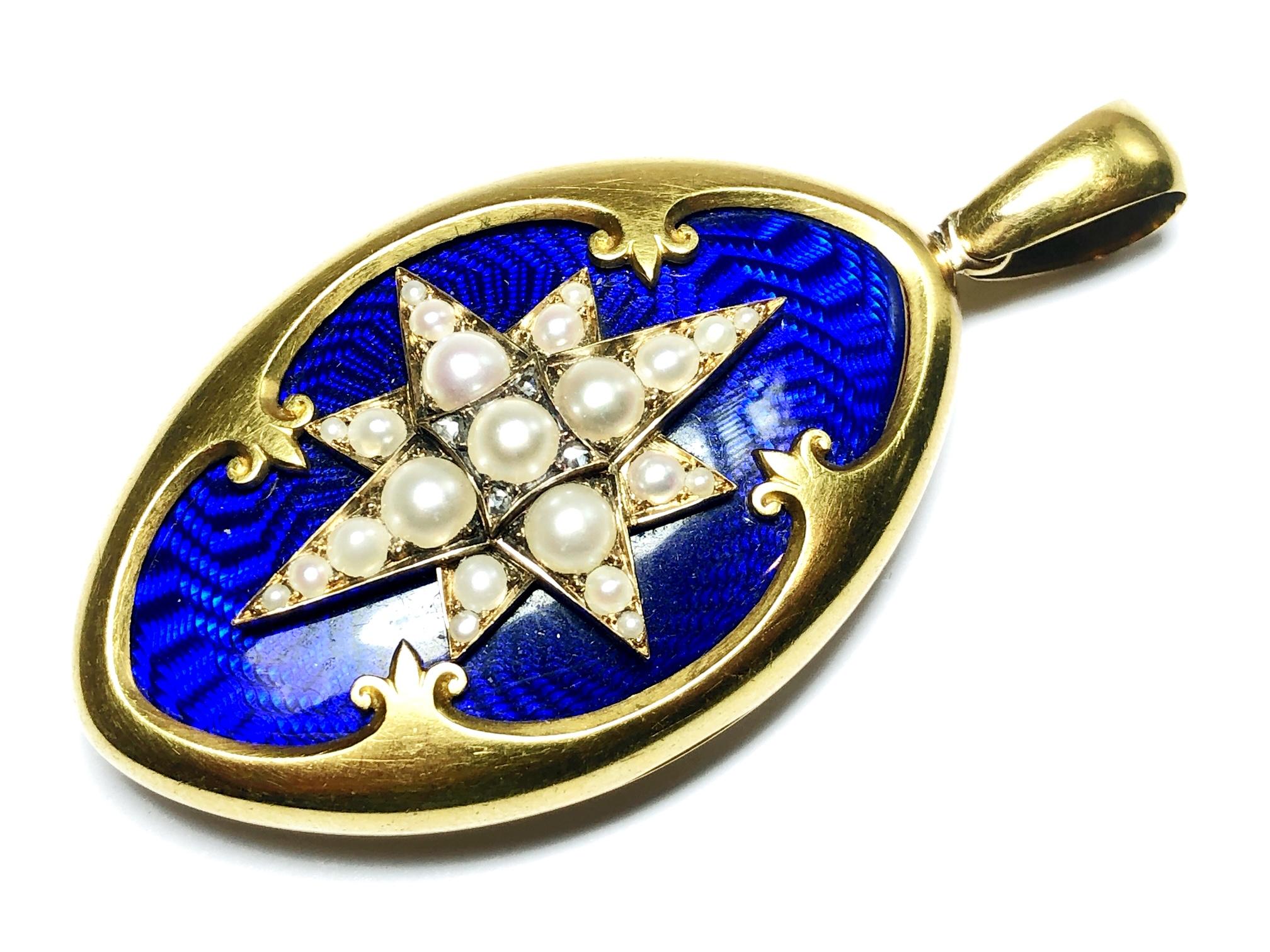 A Victorian blue enamel, seed pearl and gold locket, with a natural half pearl set star, with rose-cut diamonds, on blue guilloche enamel, mounted in gold. There is a small piece of paper, used as a backing, within the locket, from a book, dated