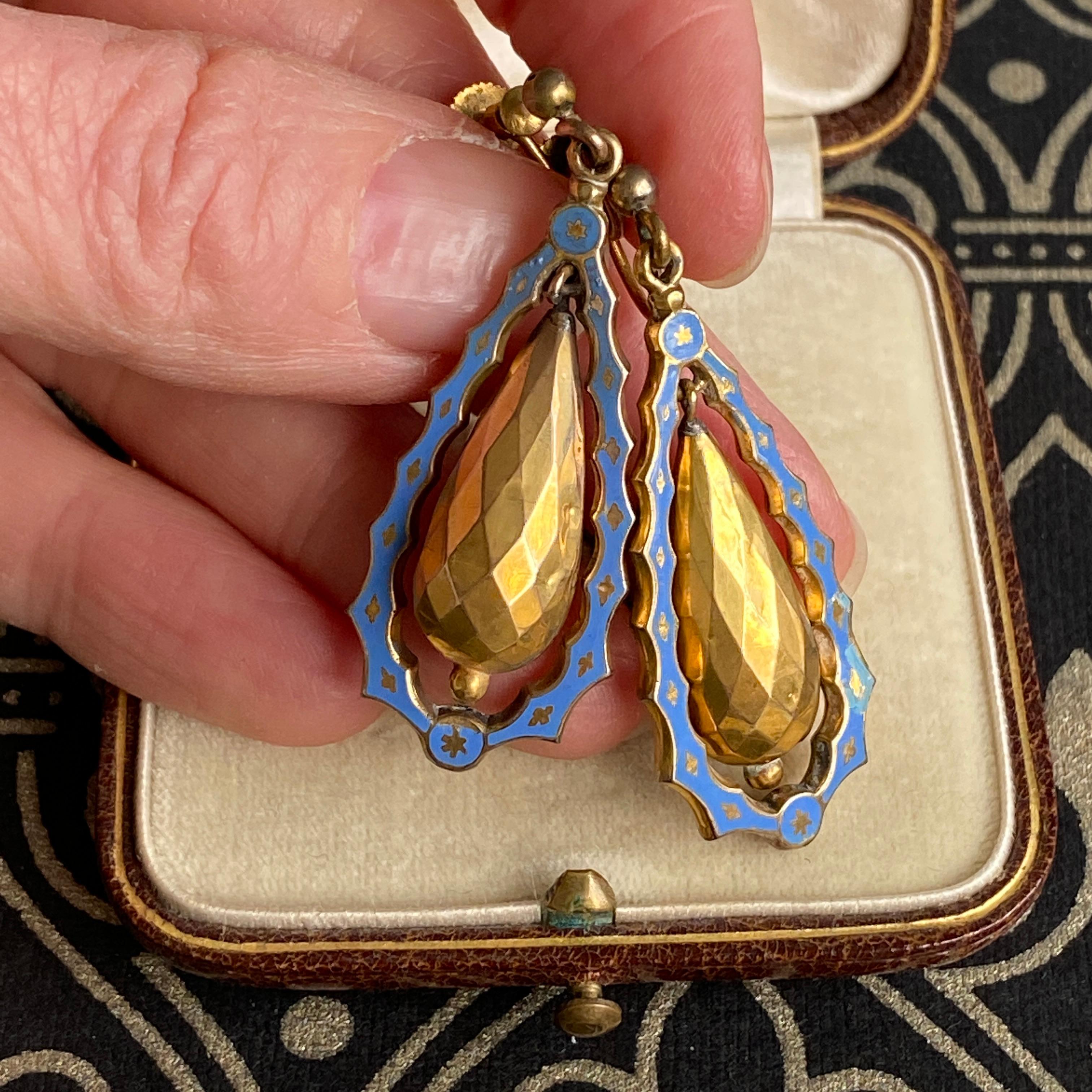 Details:
Classic blue enamel Victorian torpedo earrings set in 14K yellow gold. Fabulous faceted gold torpedo center, has movement and swings with an enamel surround. The details on these earrings are fun, and classic—a very timeless pair! These