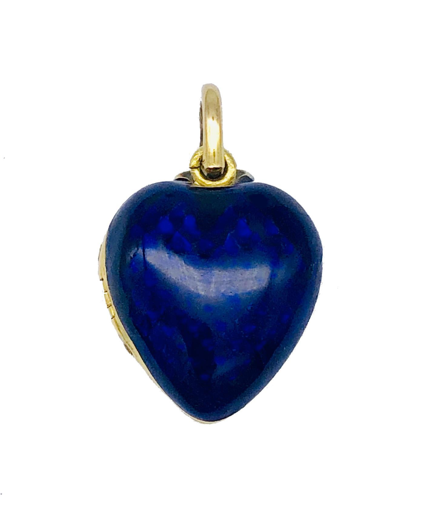 This very charming heart locket and it's chain are made out of 18 karat gold. Back and front are covered in translucent blue enamel. The front is decorated with a flower. The flower and the leaves are made out of silver and set with old cut