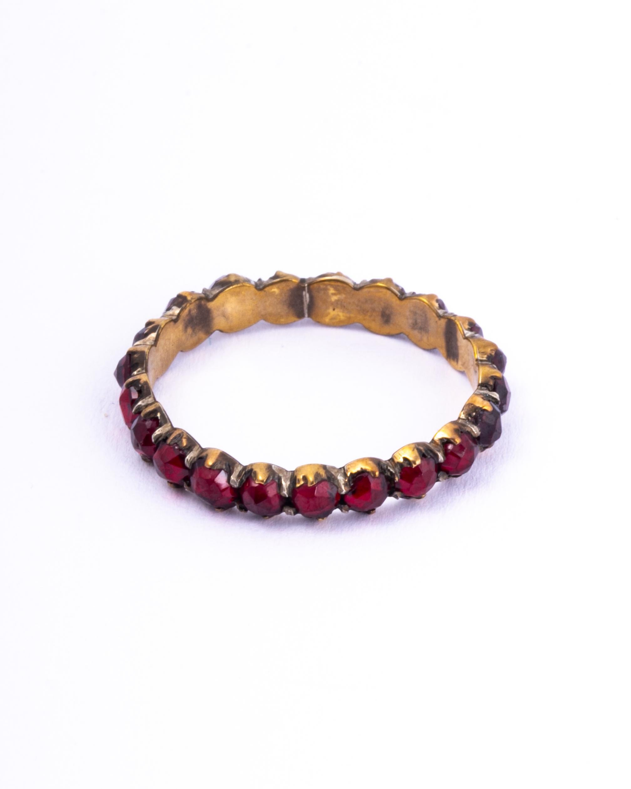 This stunning band holds a total of 21 garnets. Each stone is a deep red colour but has a bright red glow in the light. 

Ring Size: R or 8 3/4 
Band Width: 3.5mm 

Weight: 1.3g