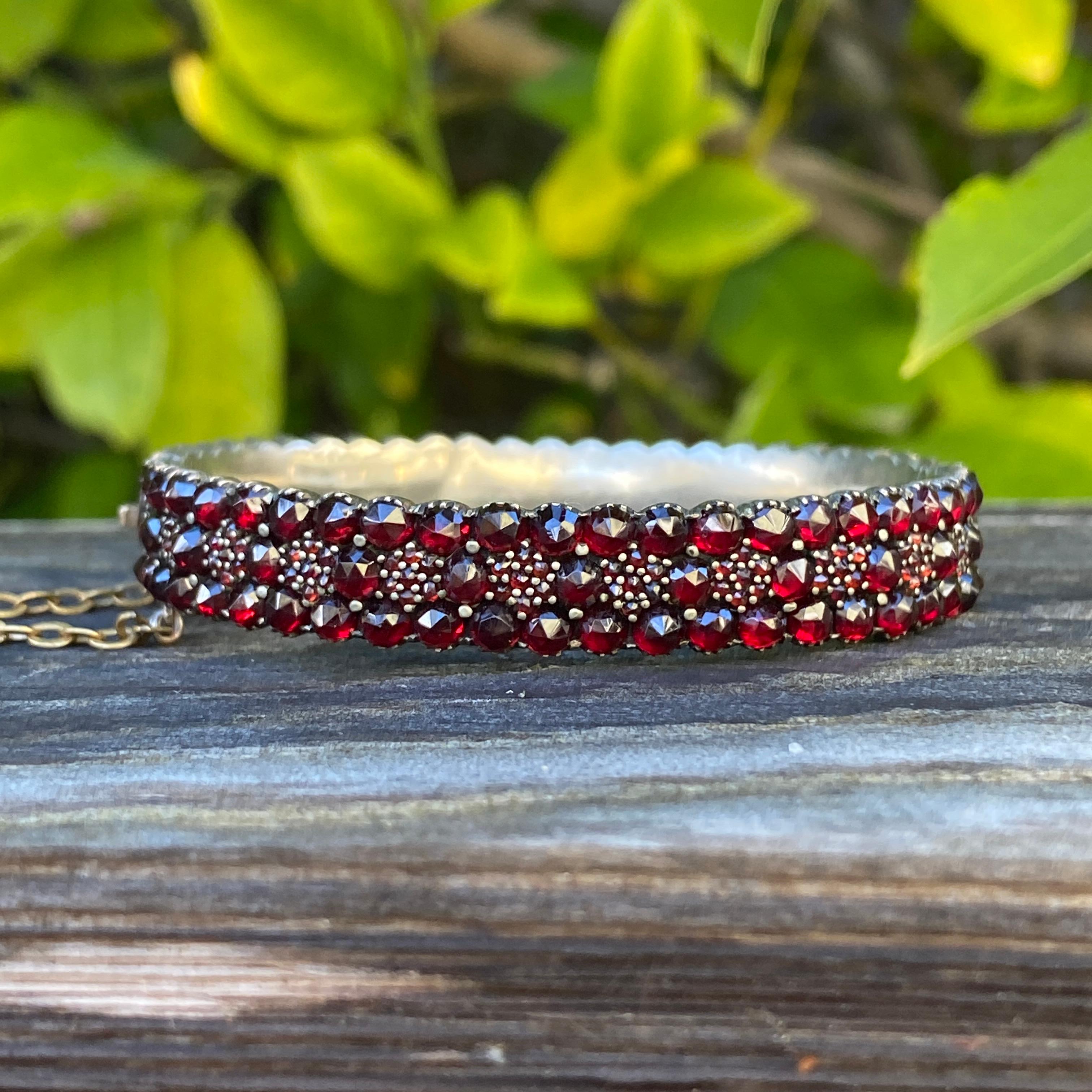Details:
Amazing Victorian Bohemian garnet bracelet encrusted in lovely deep red garnets. Nice round sparkly bangle bracelet with a lovely red glow! Beautiful floral themed bracelet with faceted garnets, prong set in silver. It’s very pretty! This