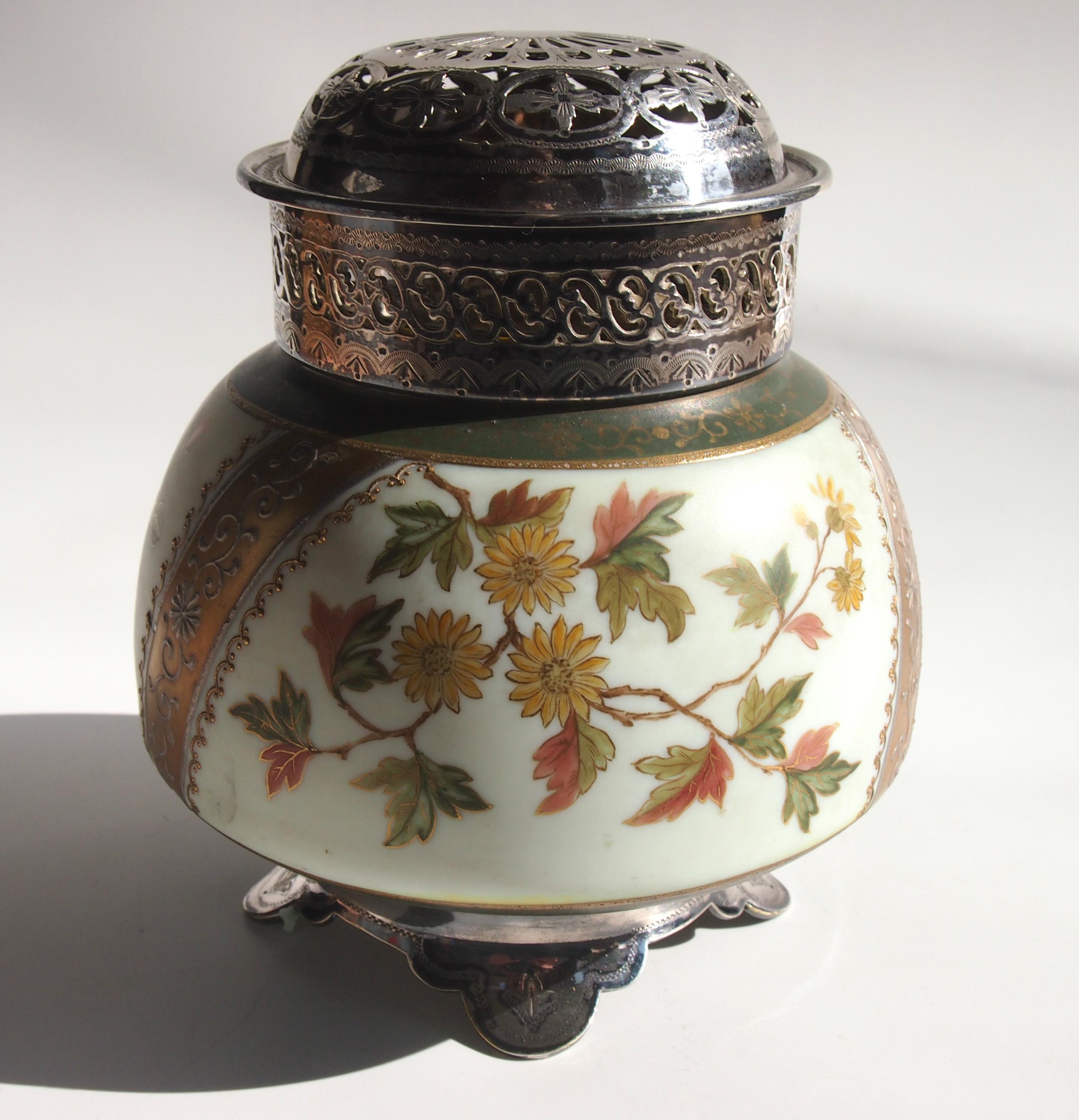 Unusual enamelled and gilded Victorian Harrach Potpurri holder with original white metal feet and collar with detachable pierced lid and separate two part inner filter made c1890. With an opaque cream base, it is enamelled with green gilded bands