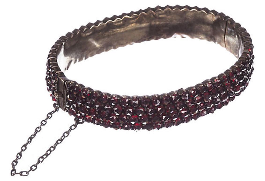 1860's Victorian rose cut garnet bangle set in base metal with gold gilt wash. Measures 2.25