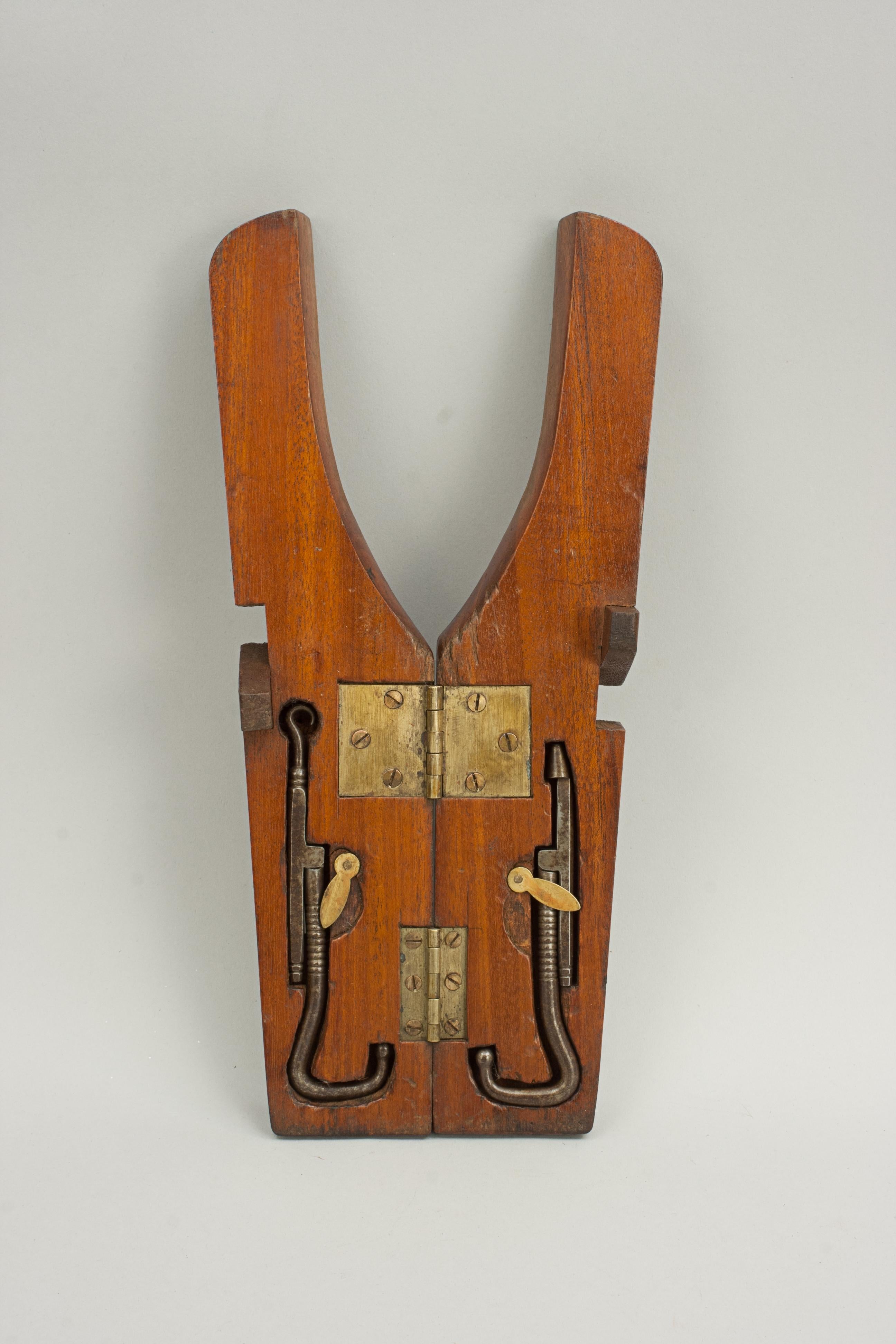 Victorian Folding Boot Jack.
A useful folding portable, campaign boot jack with boot pulls. The boot jack is made to a fairly standard design and the sort that could easily have been purchased from the Army & Navy stores. The mahogany boot jack has