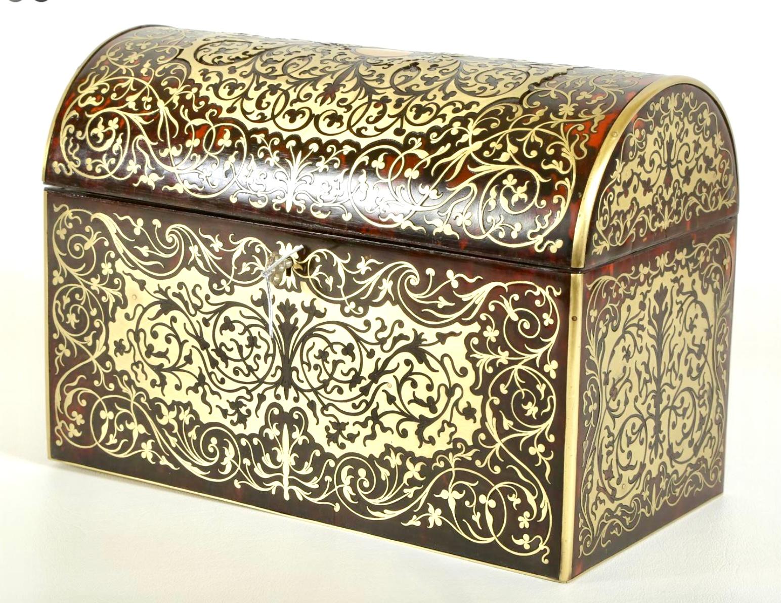 A 19th century Victorian Boulle dome-top letter box is a luxurious and distinctive piece of mail storage that combines functionality with ornate design, reflecting the opulence of the Victorian era.
This Unique letter box is decorated with brass