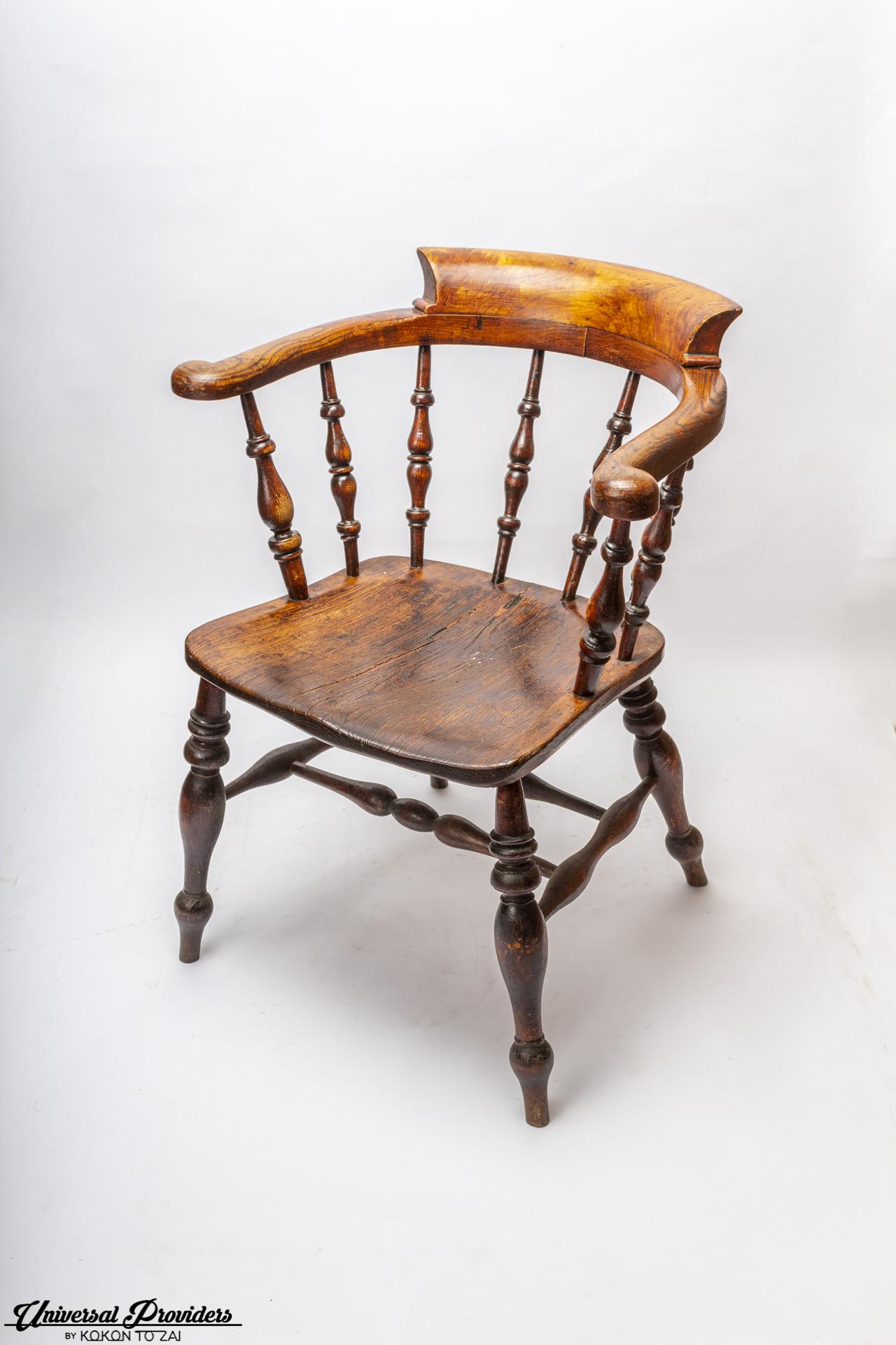 Late 1800, Victorian bow-back elbow Captain's chair made with turned spindles and a beautiful scrolled arm rest. Made of elm. Solid construction with beautiful patina.