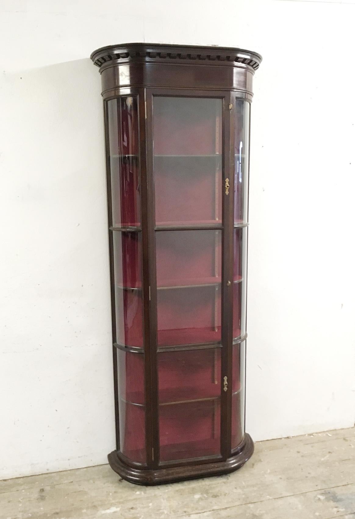 Bow fronted curved glass Victorian display cabinet
English 
Victorian
Mahogany
circa 1890s-1900s
Fully lined with red velvet
Adjustable velvet covered mahogany shelves, there are 5 shelves plus the bottom of the cabinet 
Bow front sides
