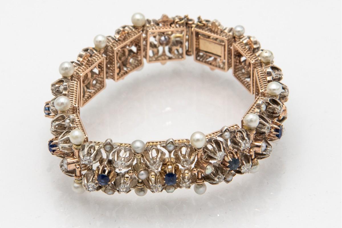 Beautiful antique bracelet with diamonds, sapphires and pearls.

Set with 48 