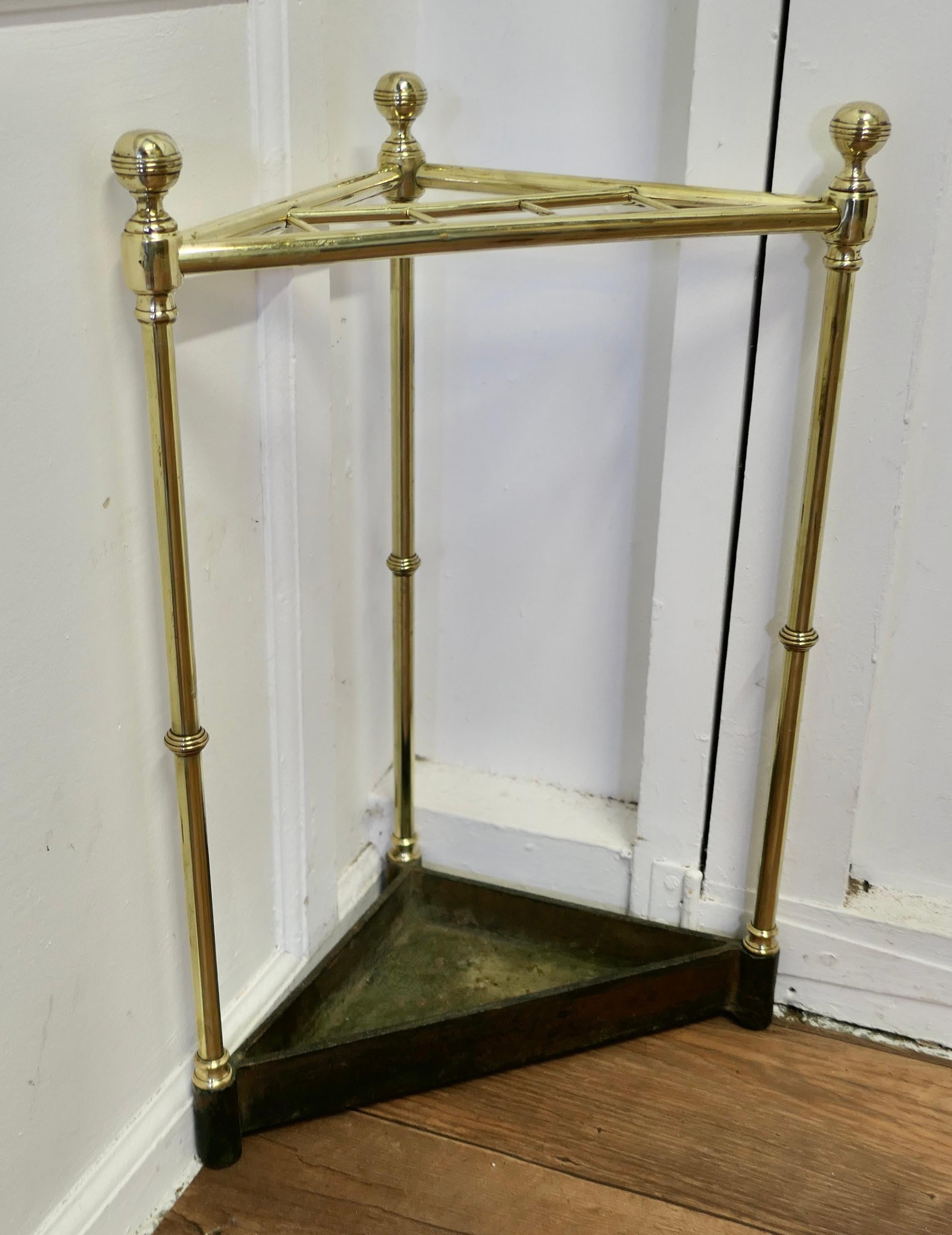 Victorian Brass and Cast Iron Corner Stick or Umbrella Stand

A charming neat little piece, the stand sits neatly in a corner, very useful where space is scarce. It has a brass rail around the top and has brass uprights topped off with stylish