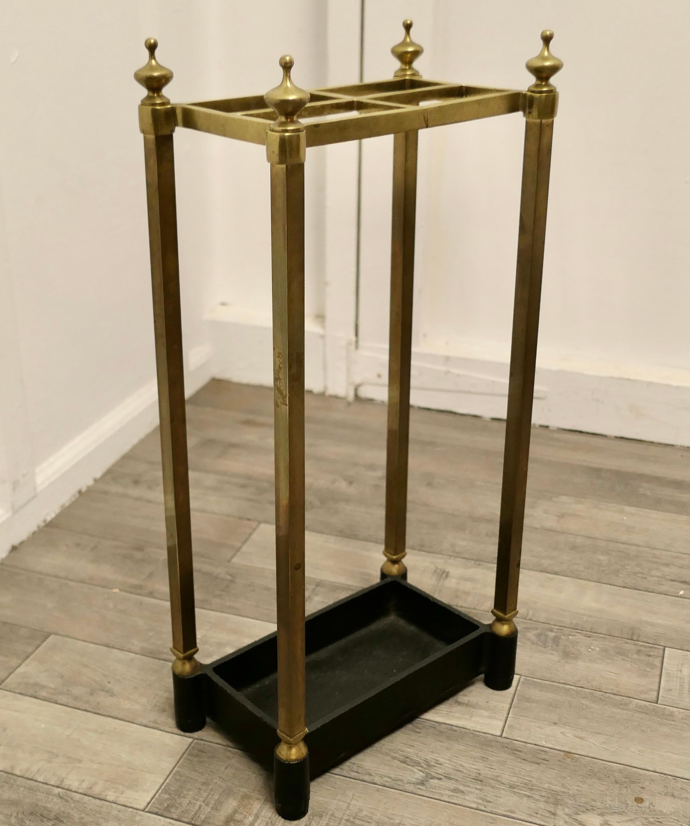 Victorian brass and cast iron umbrella stand or stick stand.

A charming piece, the stand has a brass top divided into 4 sections to hold either walking sticks or umbrellas, the heavy iron base is the drip tray
The stand is in good sturdy