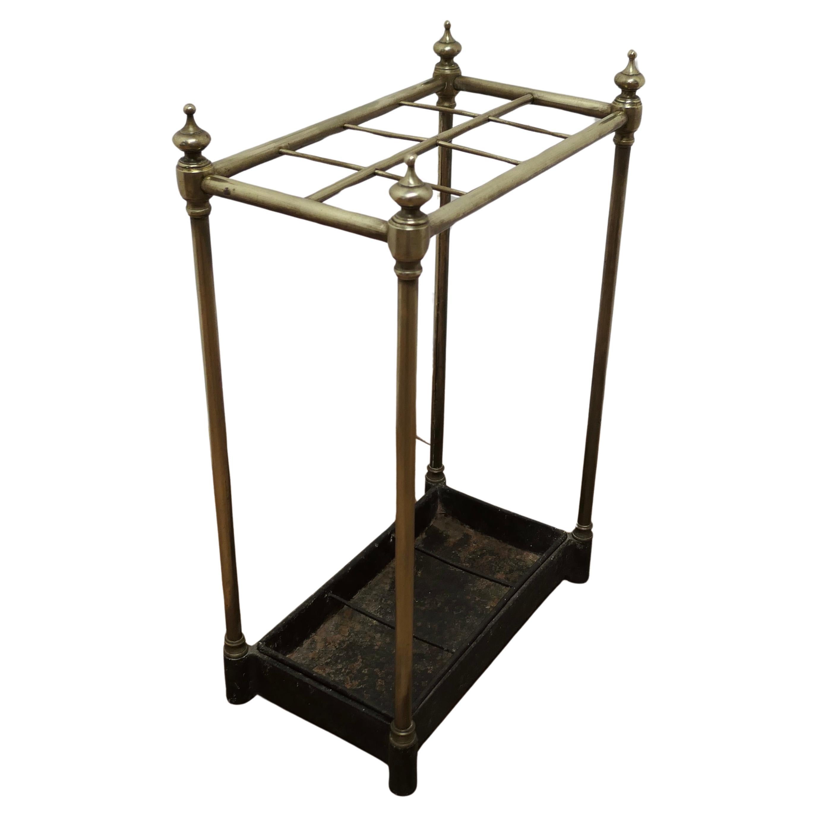Victorian Brass and Cast Iron Walking Stick Stand or Umbrella Stand

A charming piece, the stand has a brass top divided into 8 sections, more than most. to hold either Walking Sticks or Umbrellas, the heavy removable iron base is the drip tray
The