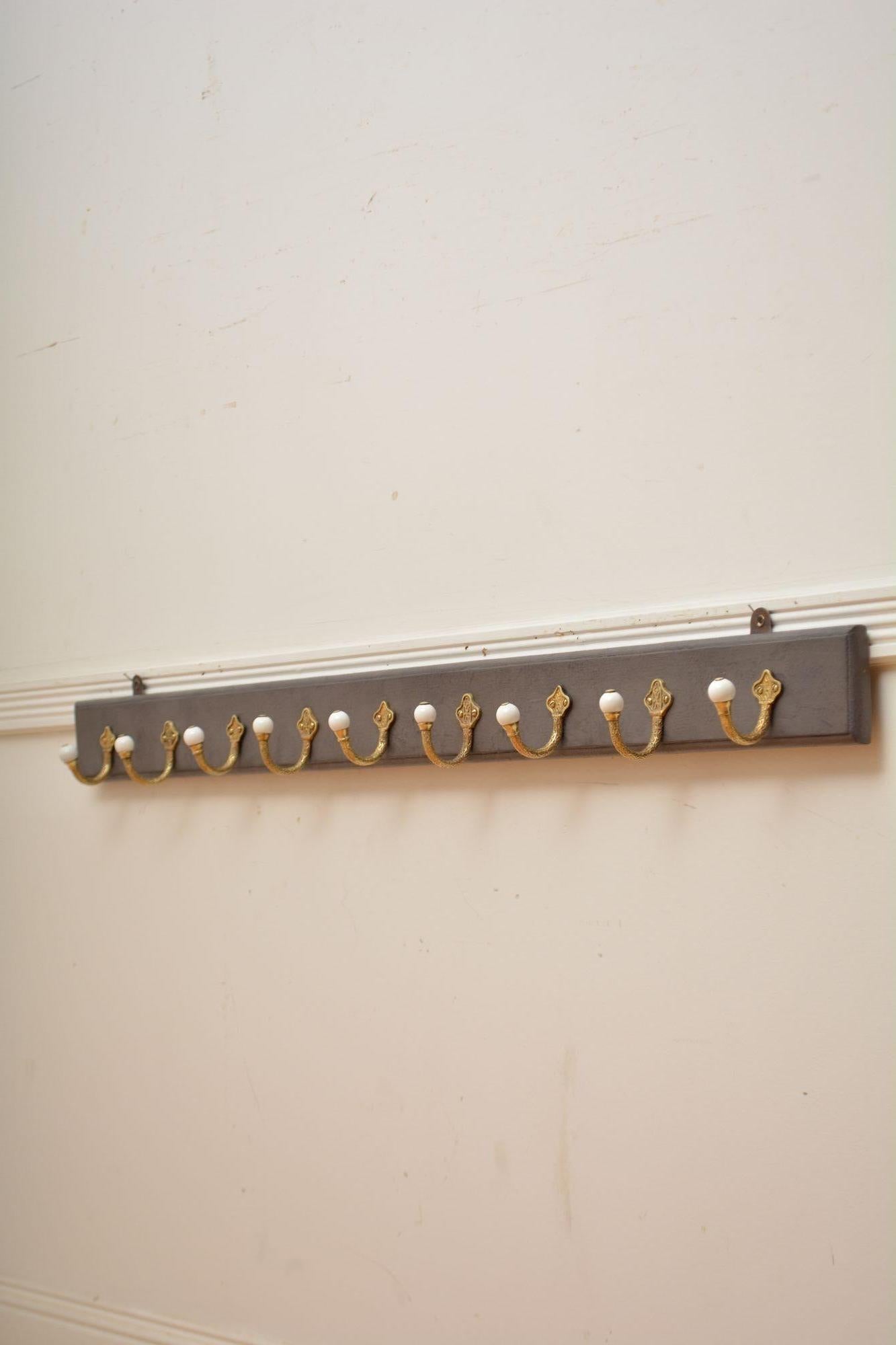 K0297 Very stylish long  set of five and four, Victorian brass and ceramic coat hooks on grey painted pine with moulded edge. Fitted with two wall fixings, all in home ready condition. c1880
H4