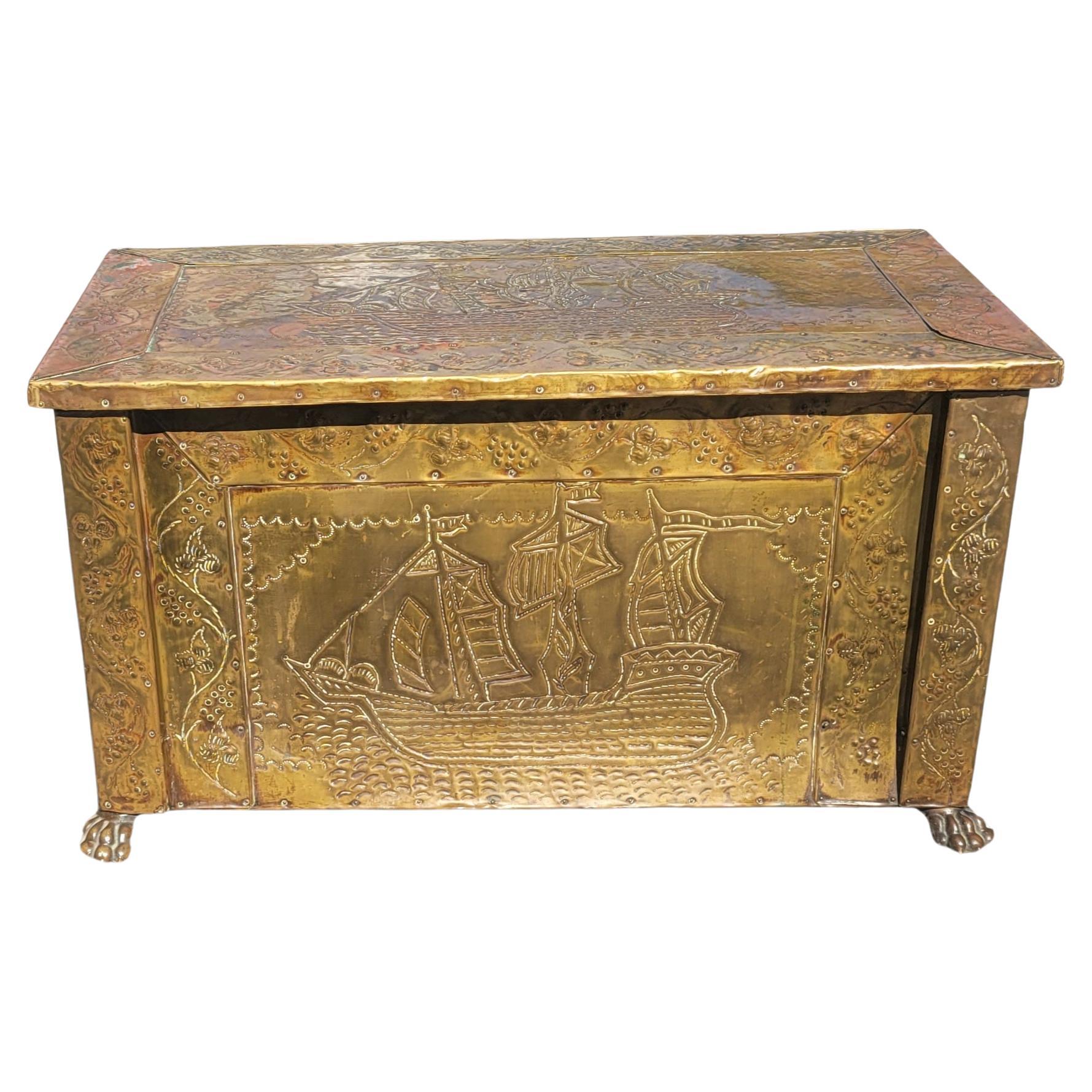 A rare Victorian Brass and copper 
 repousse designs over wood coal or fireplace Logs Chest with lion paw feet. Repousse brass ornate with ships design on front and top. 
Measures 31