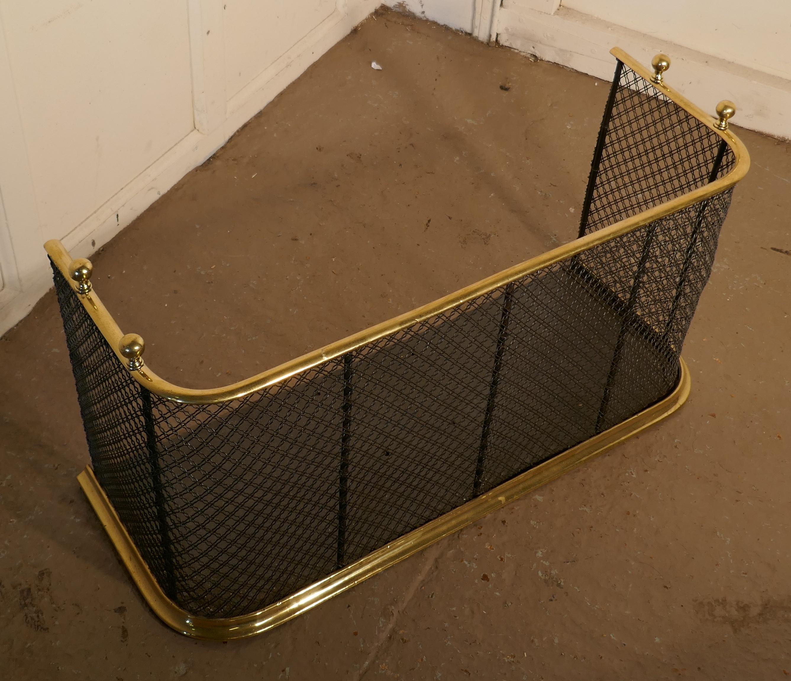 A Victorian brass and iron fender or fireguard
 
A Victorian antique fire guard often known as a Club Fender, the iron guard has wire mesh and brass rails top and bottom, it has brass knobs on the top, the fender is in good all round condition