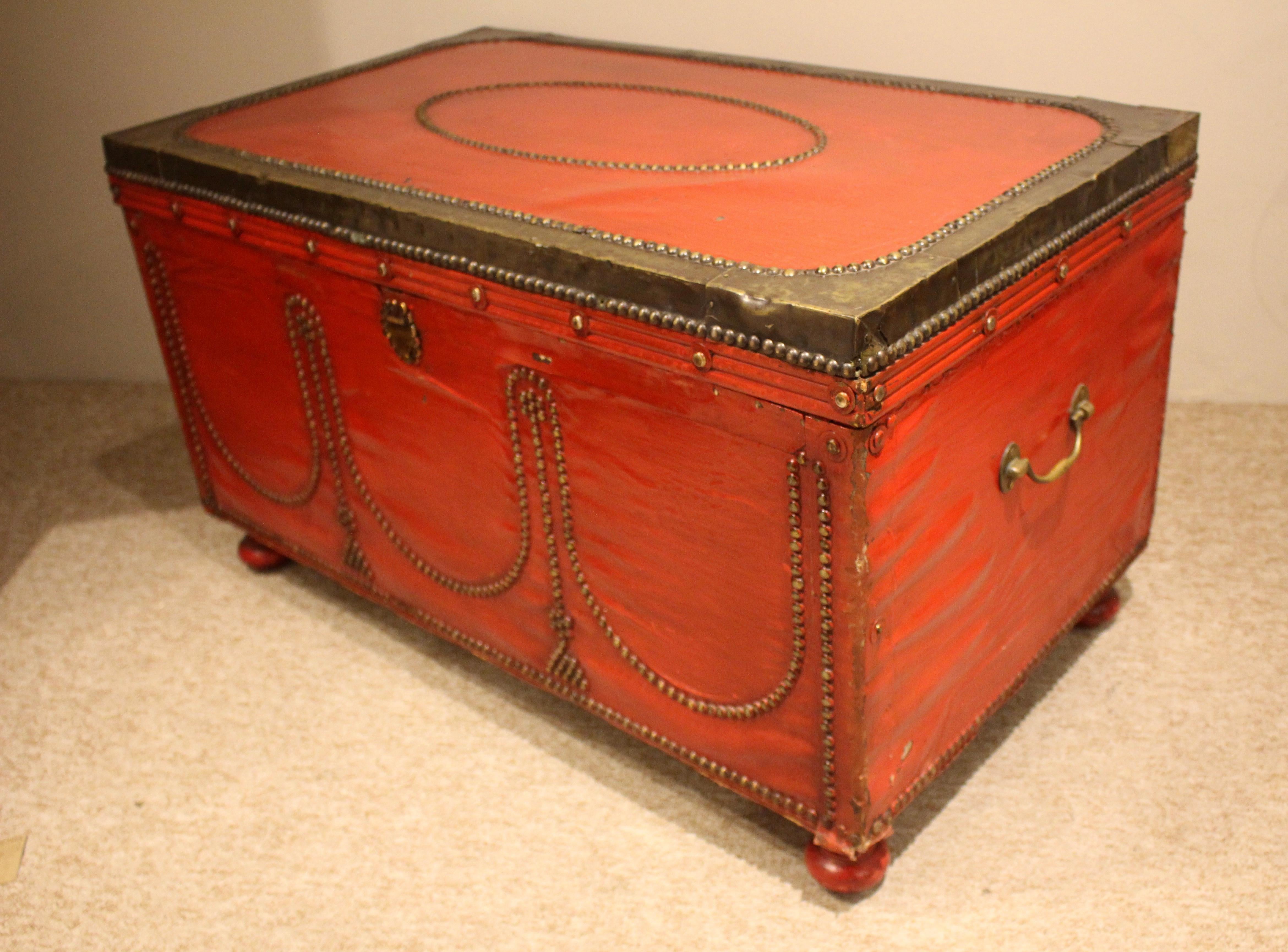 An old Victorian brass bound trunk. Nicely decorative with the stud detail and rich color. Stand on four bun feet. Could be used as a central coffee table, side table or just a good old fashioned trunk!