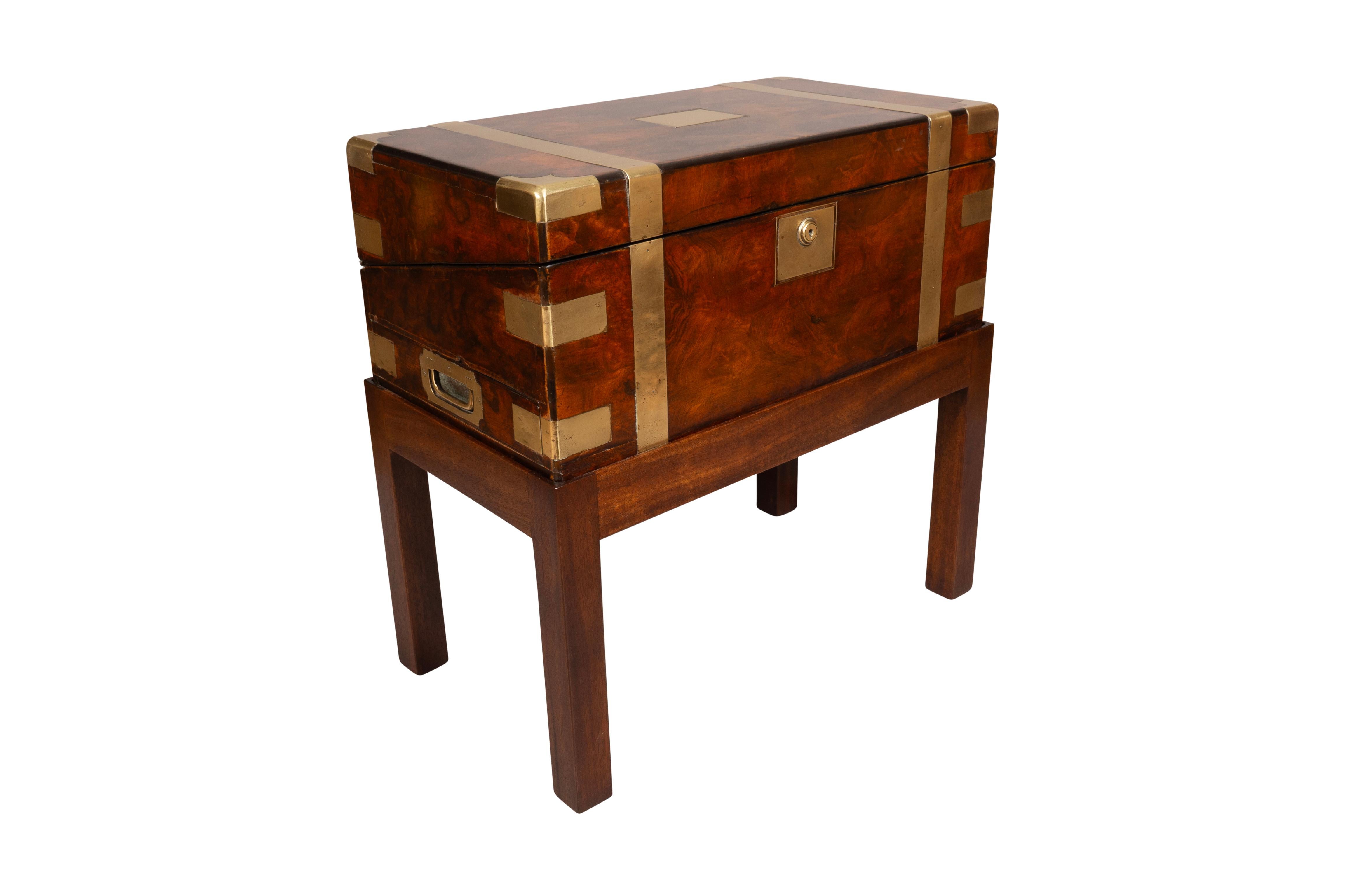 The box originally a traveling desk with green leather desk section and fitted compartments. Burl walnut case with brass strapping. Key included. Later mahogany base.
Makes a nice side table.
