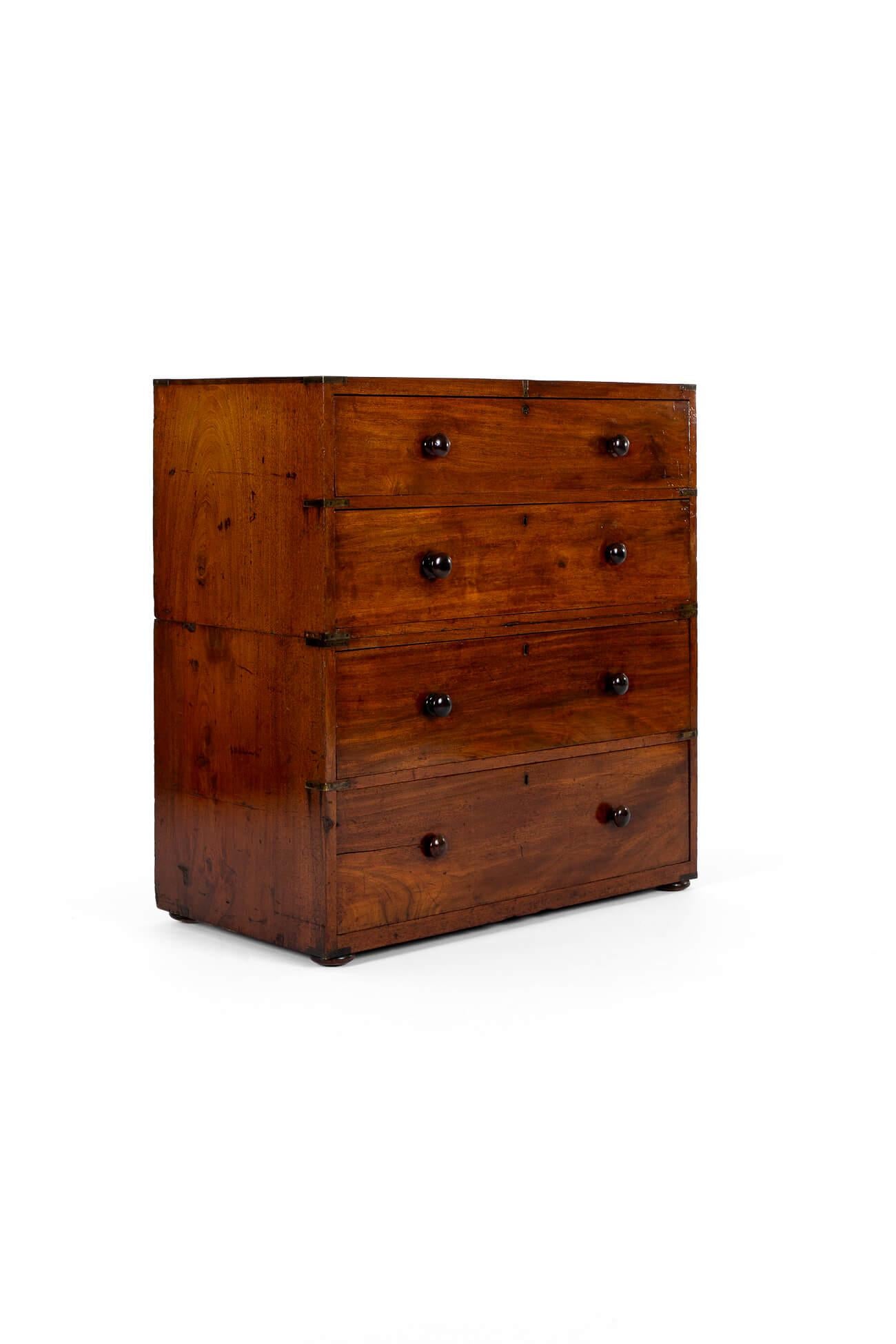 A superb gentleman’s Victorian brass bound campaign chest in mahogany.

The chest splits into two sections, the upper displaying a caddy top and two long drawers. The lower also features two long drawers raised on bun feet. Mahogany handles to both